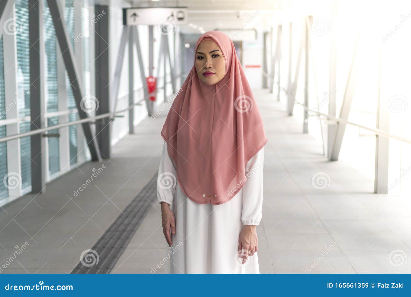 Asian Muslim  Lady At The Train  Station Wearing Hijab  Stock 