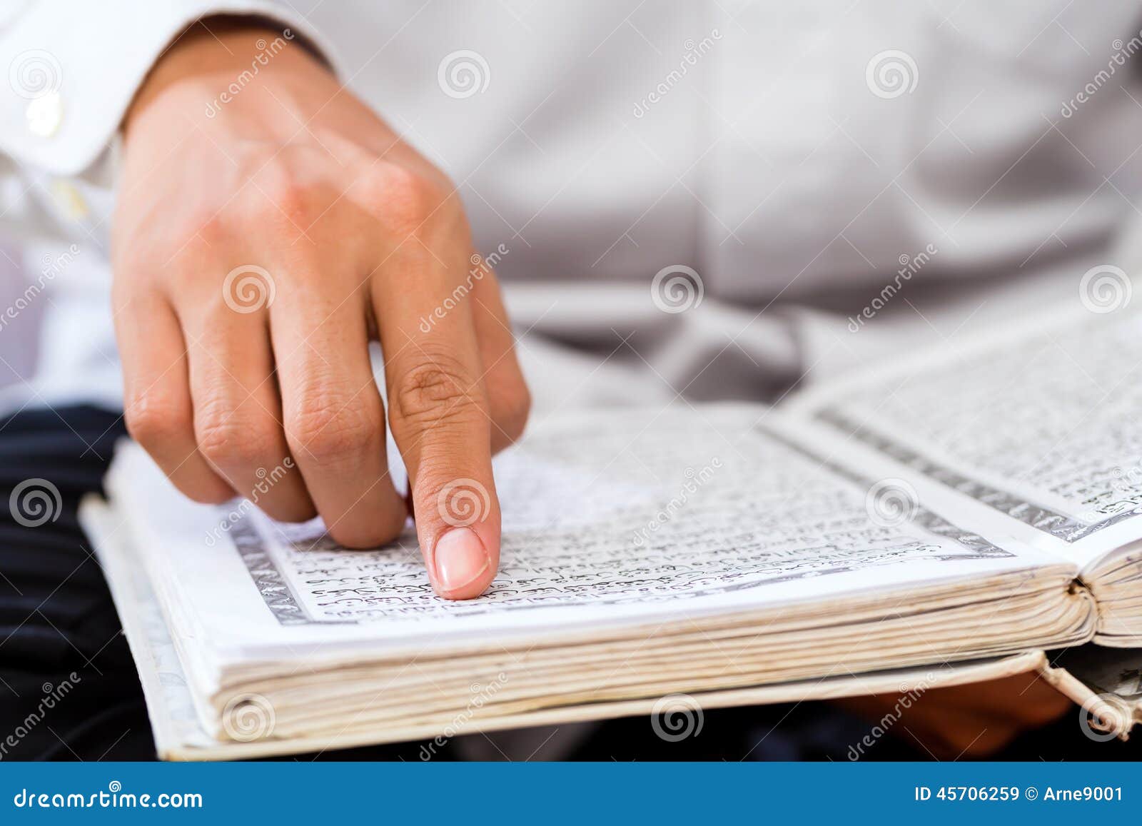 asian muslim man studying koran or quran