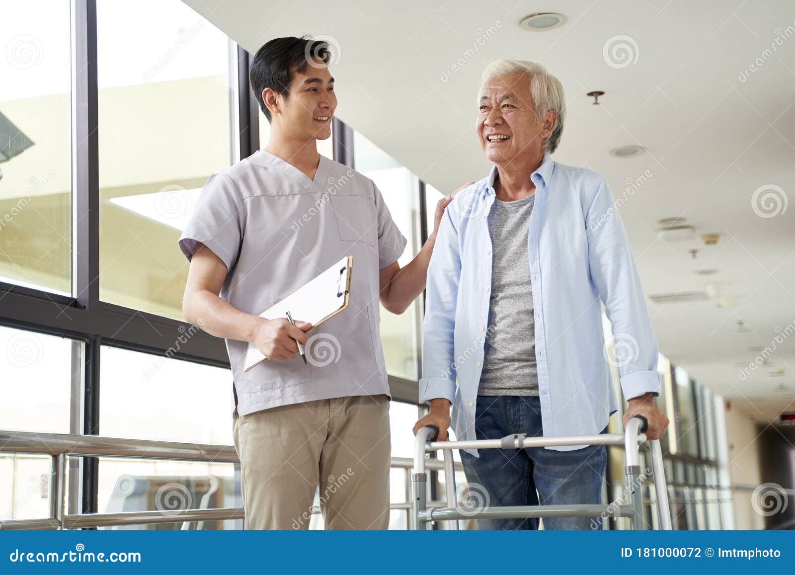 asian old man talking to physical therapist in rehab center