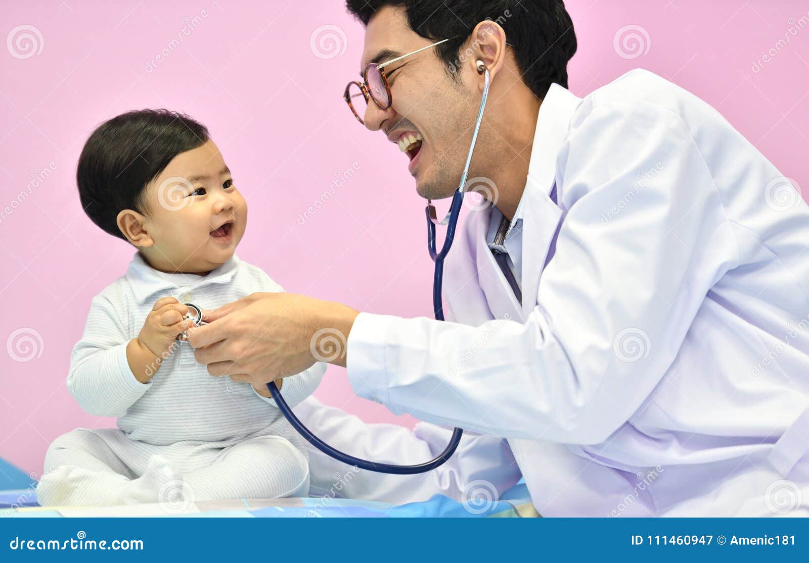 asian paediatrician examining a baby with a stethoscope