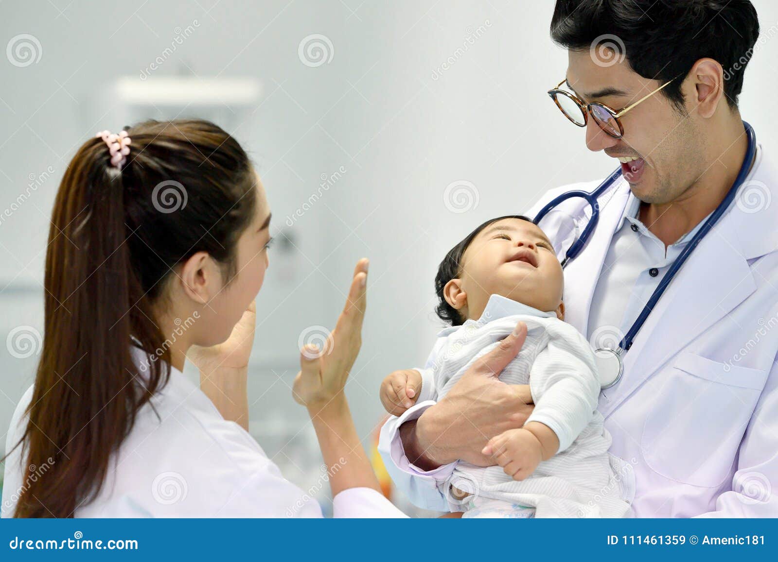 asian paediatrician is taking care of baby