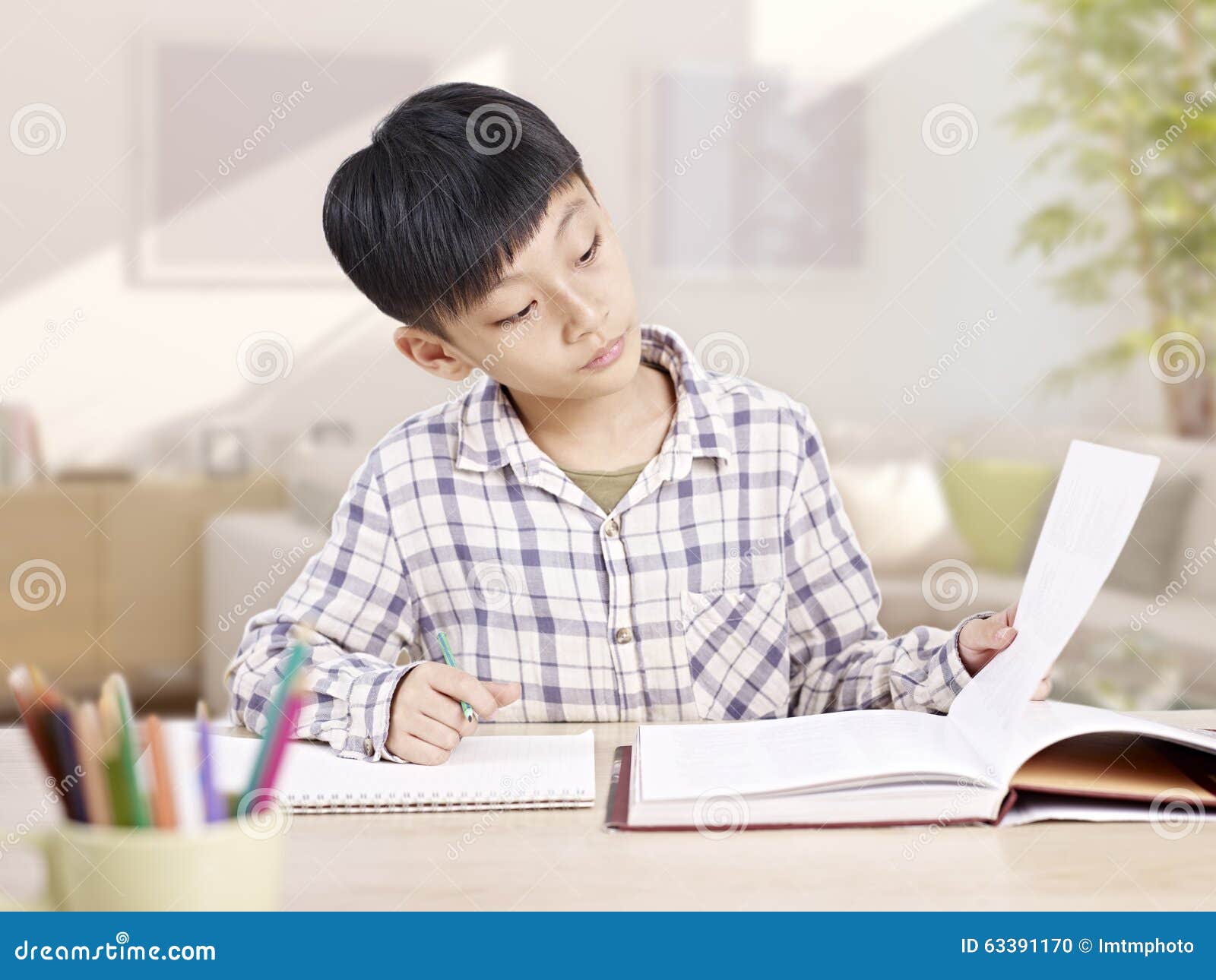 asian schoolboy studying at home