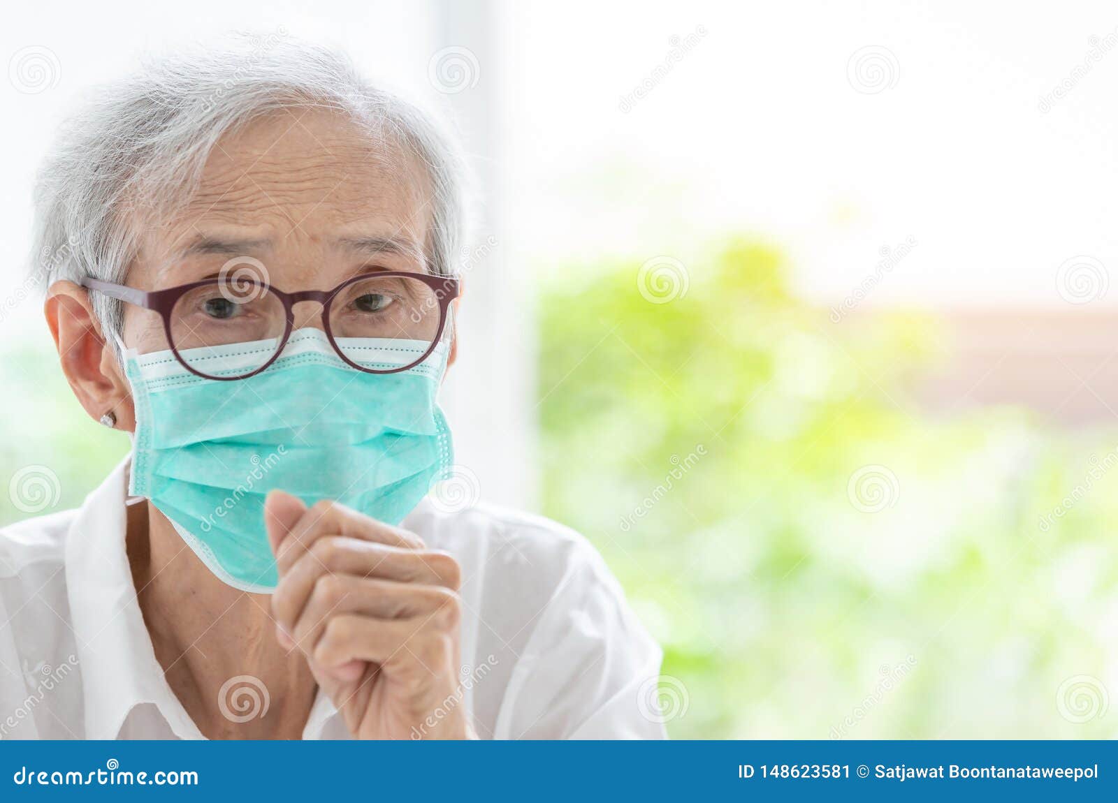 asian senior woman suffer from cough with face mask protection,elderly woman wearing face mask because of air pollution,sick old