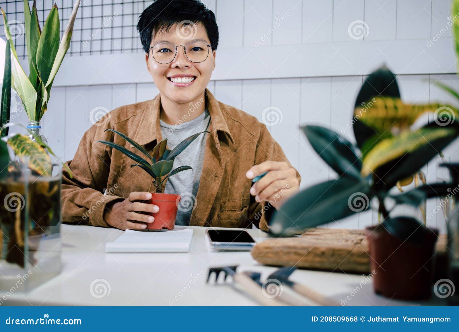 Asian Short Hair Woman Smiling and Holding Plant Pot To Write Down Reports on the Growth of Potted Plants on His Desk with Home Stock Photo - Image of looking, grow: 208509668 Asian Short Hair Woman Smiling and Holding Plant Pot To Write Down Reports on the Growth of Potted Plants on His Desk with Home Stock Photo - Image of looking, grow: 208509668