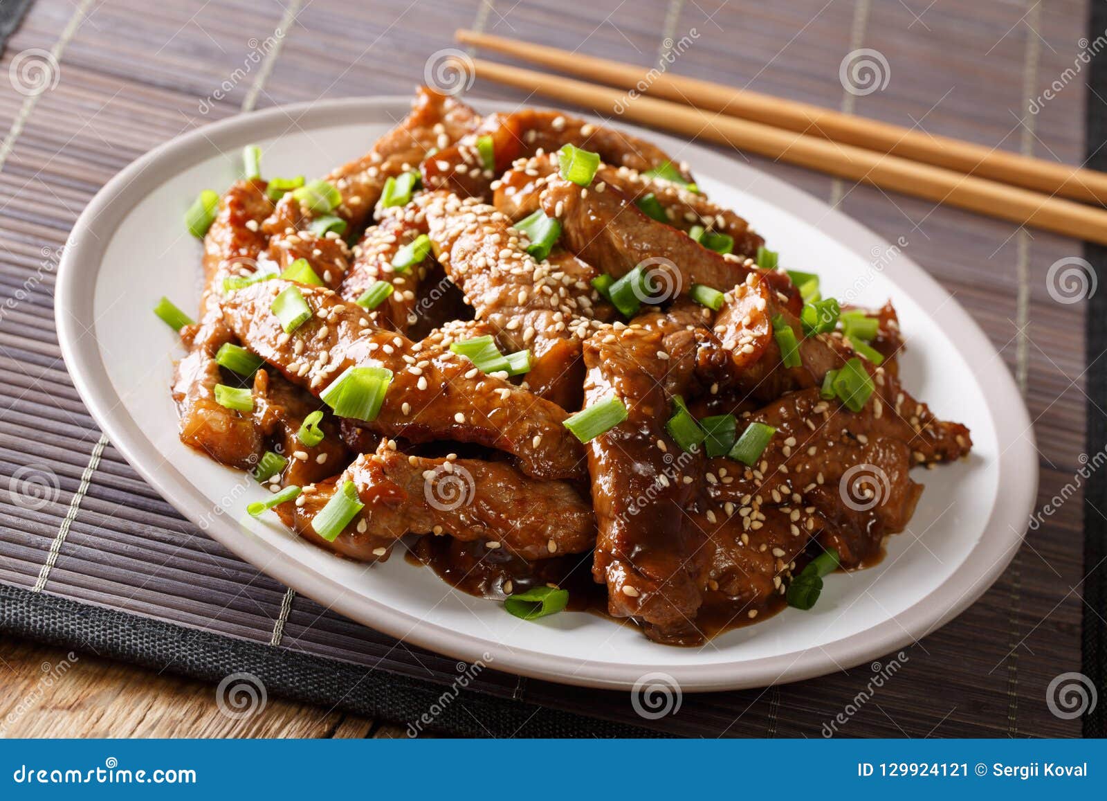 Asian Stir-fried Beef in Teriyaki Sauce with Sesame and Green on Stock