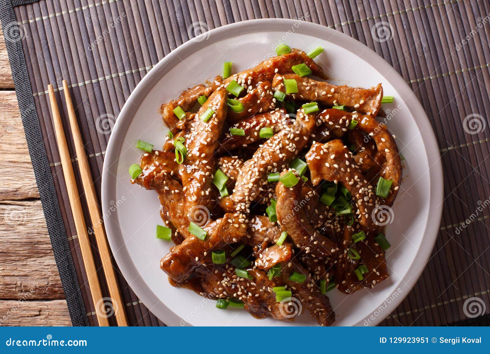 Asian Stir-fried Beef in Teriyaki Sauce with Sesame and Green on Stock