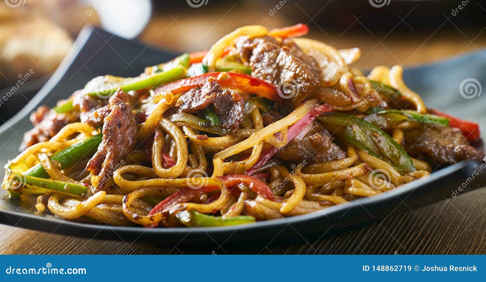 Asian Stir Fried Noodles with Beef Peppers and Onions Panorama Stock ...