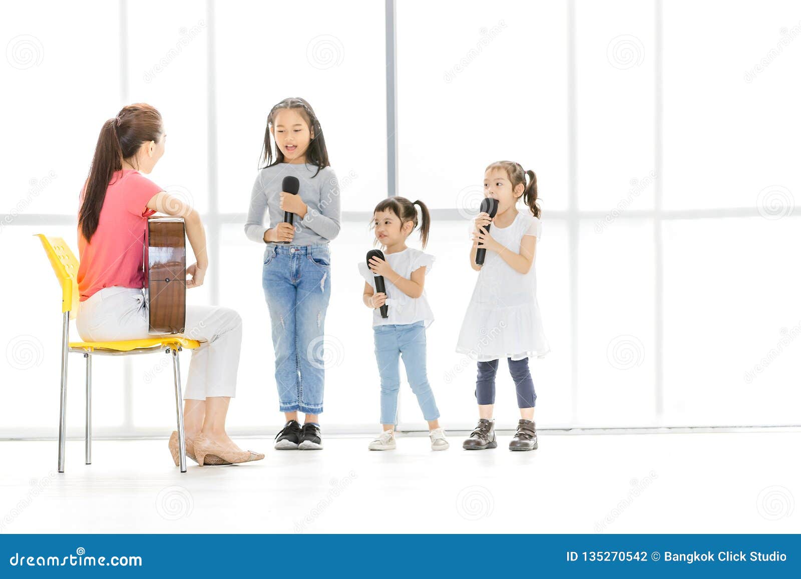Asian Teacher Is Teaching Children To Sing Stock Photo