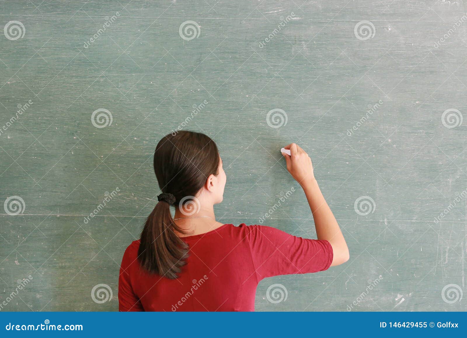 Asian Teacher Writing on Blackboard with Chalk in Classroom, Educations