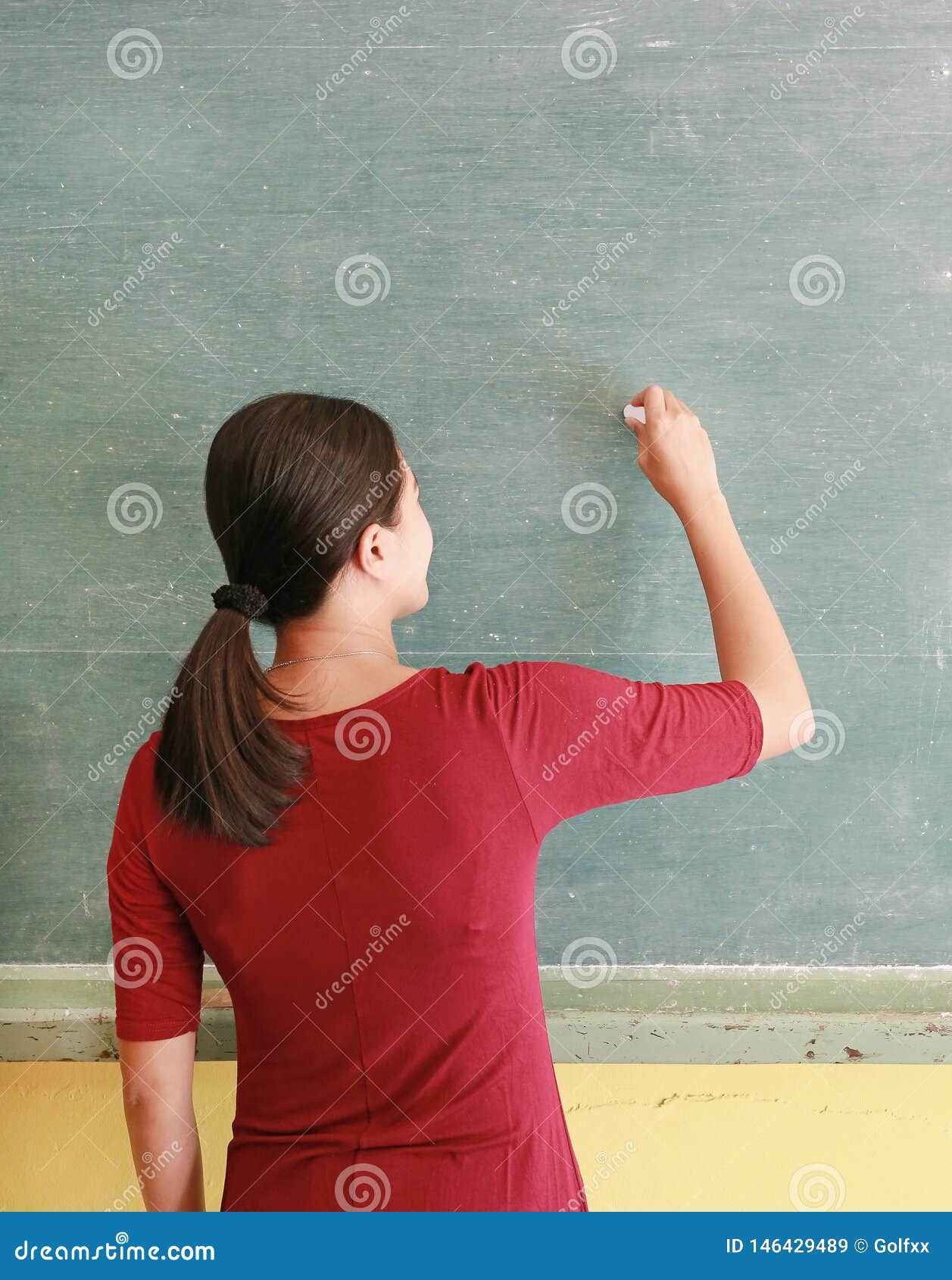 Asian Teacher Writing on Blackboard with Chalk in Classroom, Educations
