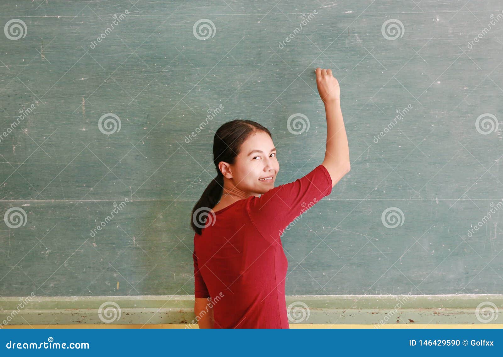 Asian Teacher Writing on Blackboard with Chalk in Classroom, Educations