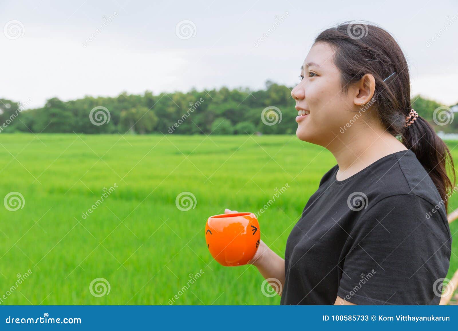 Asian Teen Fat Women Side View Hold Mug With Green Nature Stock Image