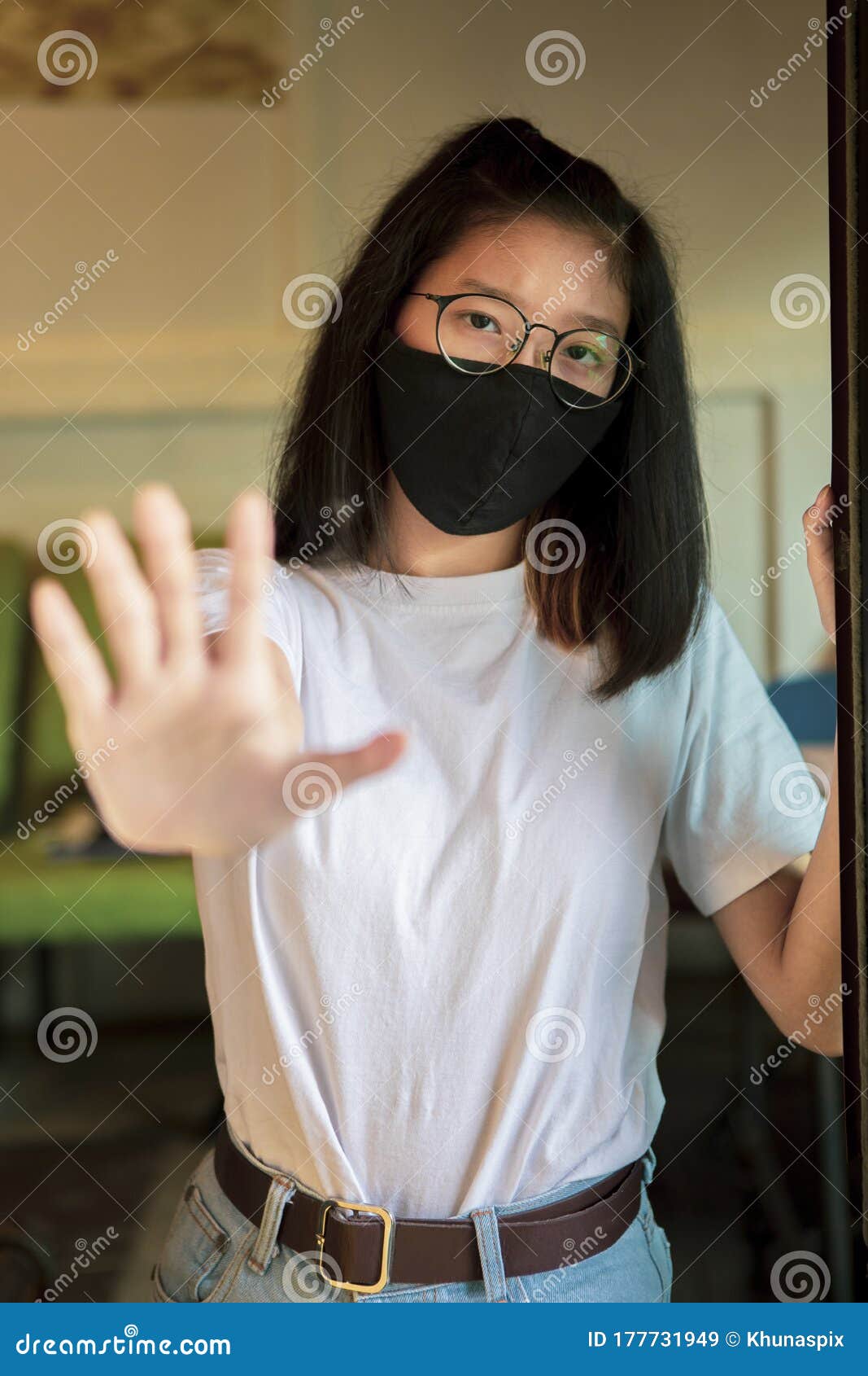 asian teenager wearing protection mask and hand sign to not closer
