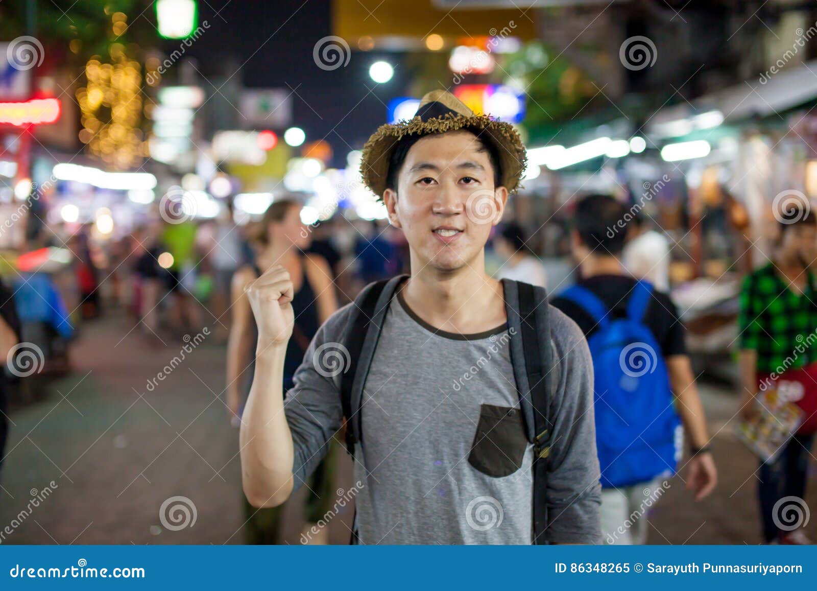 Asian Tourist Pointing at the Back in Asia Night Market Stock Image