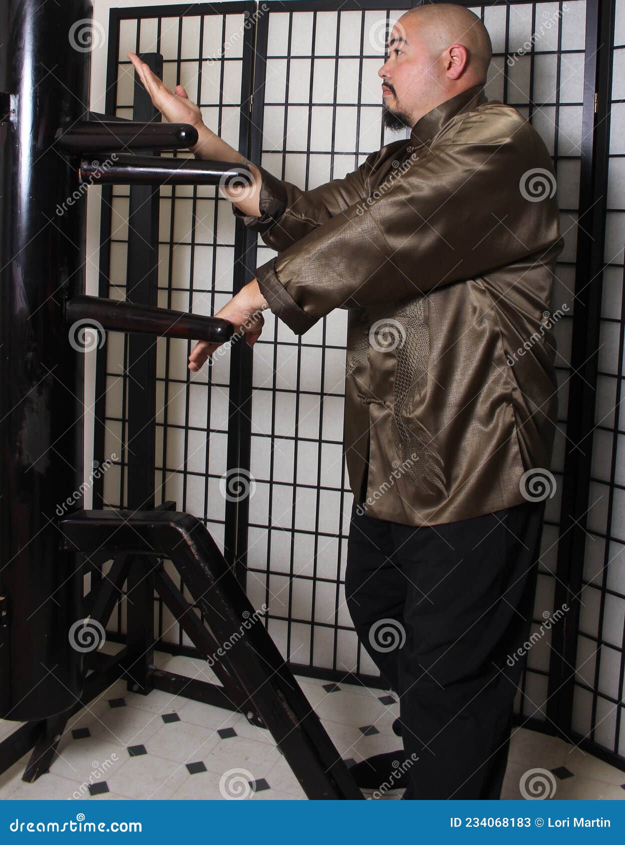 Asian Wing Chun Instructor Practicing Wooden Dummy Form Stock Image