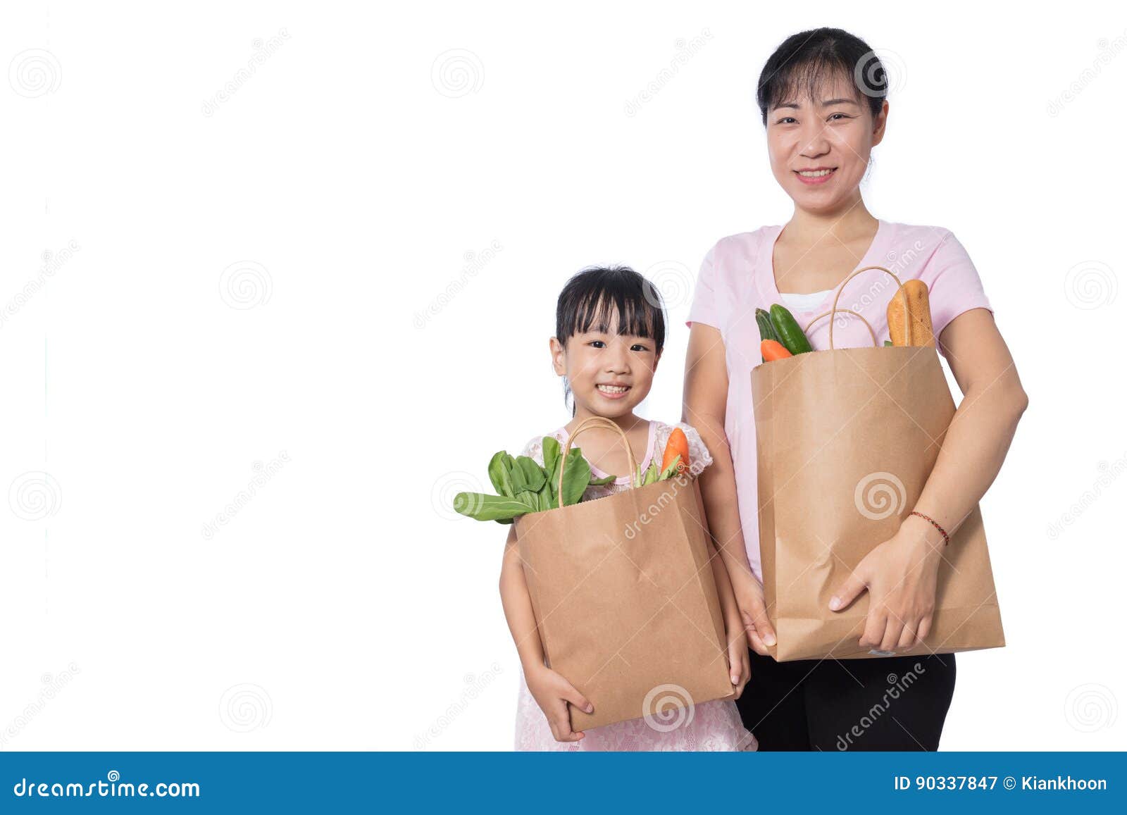 asian woman and daughter carrying groceries