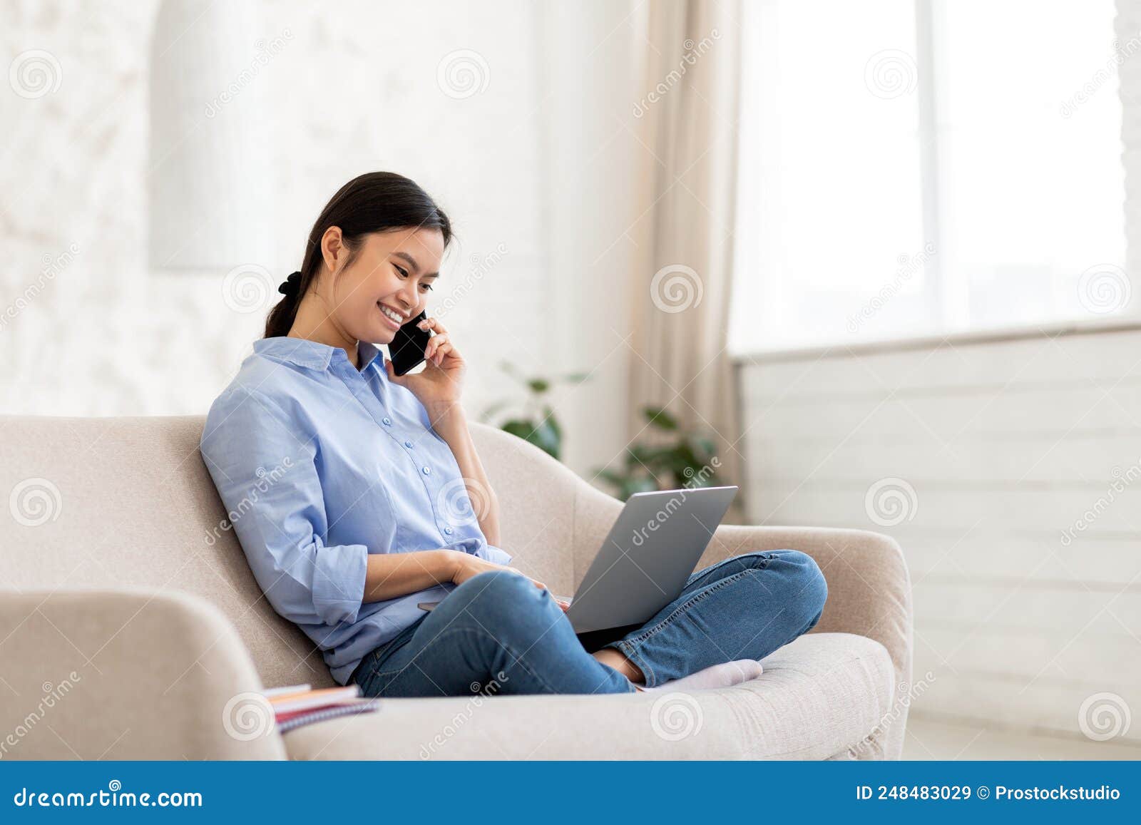 Asian Woman Entrepreneur Working from Home, Having Phone Call Stock