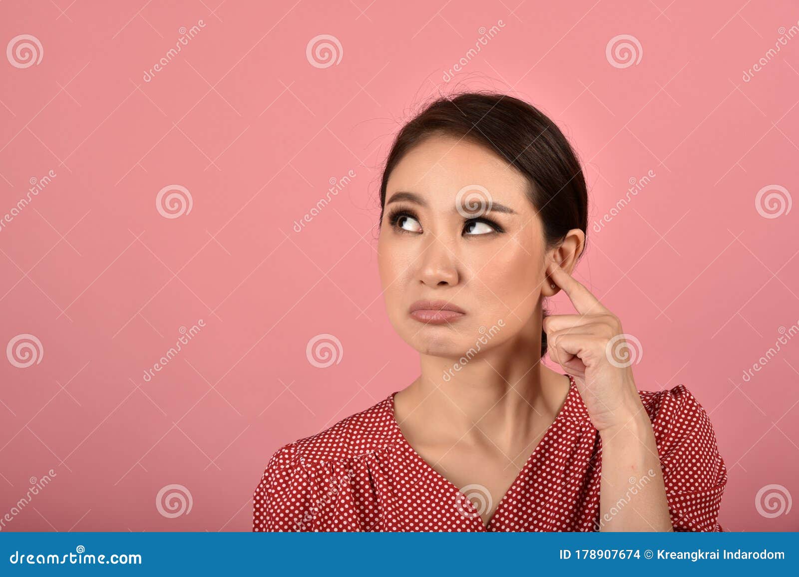 asian woman feeling upset and frustrated, girl rolling eyes with boredom and annoy about gossip.