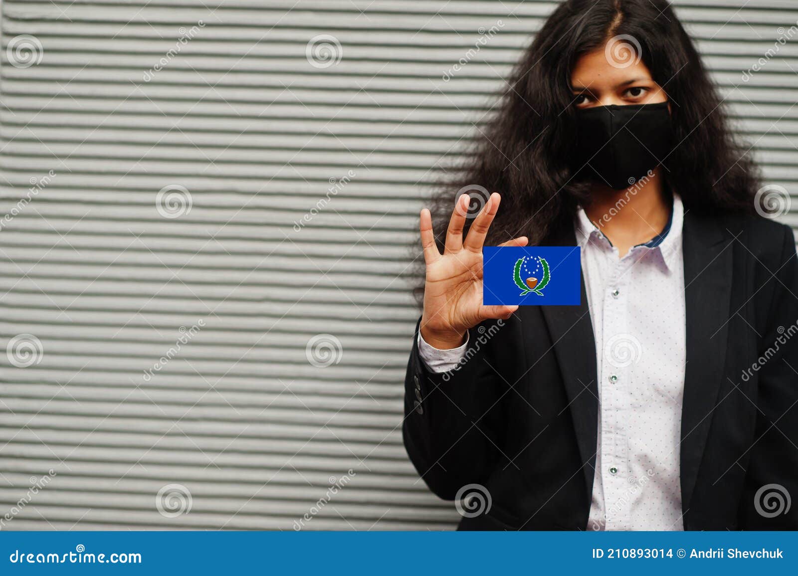 asian woman at formal wear and black protect face mask hold pohnpei flag at hand against gray background. coronavirus at country