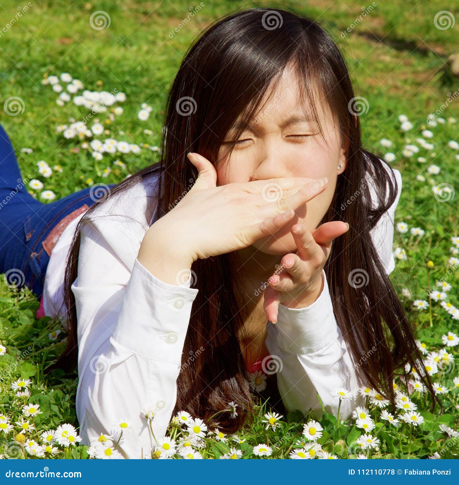 Asian Woman with Allergy in Spring Lying on Grass Closeup Stock Photo