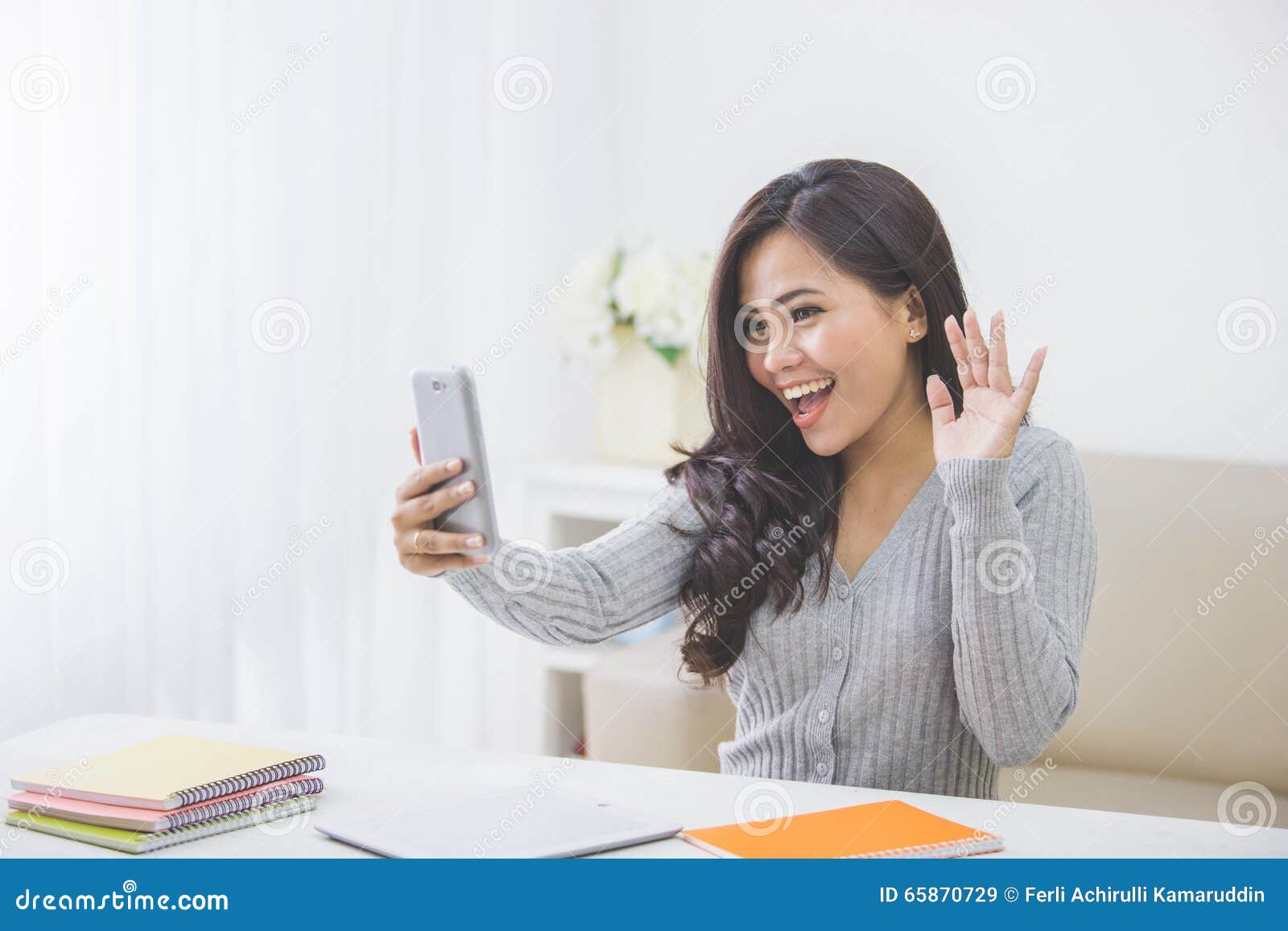 Asian Woman at Home Making a Video Call Using Smart Phone Stock Image