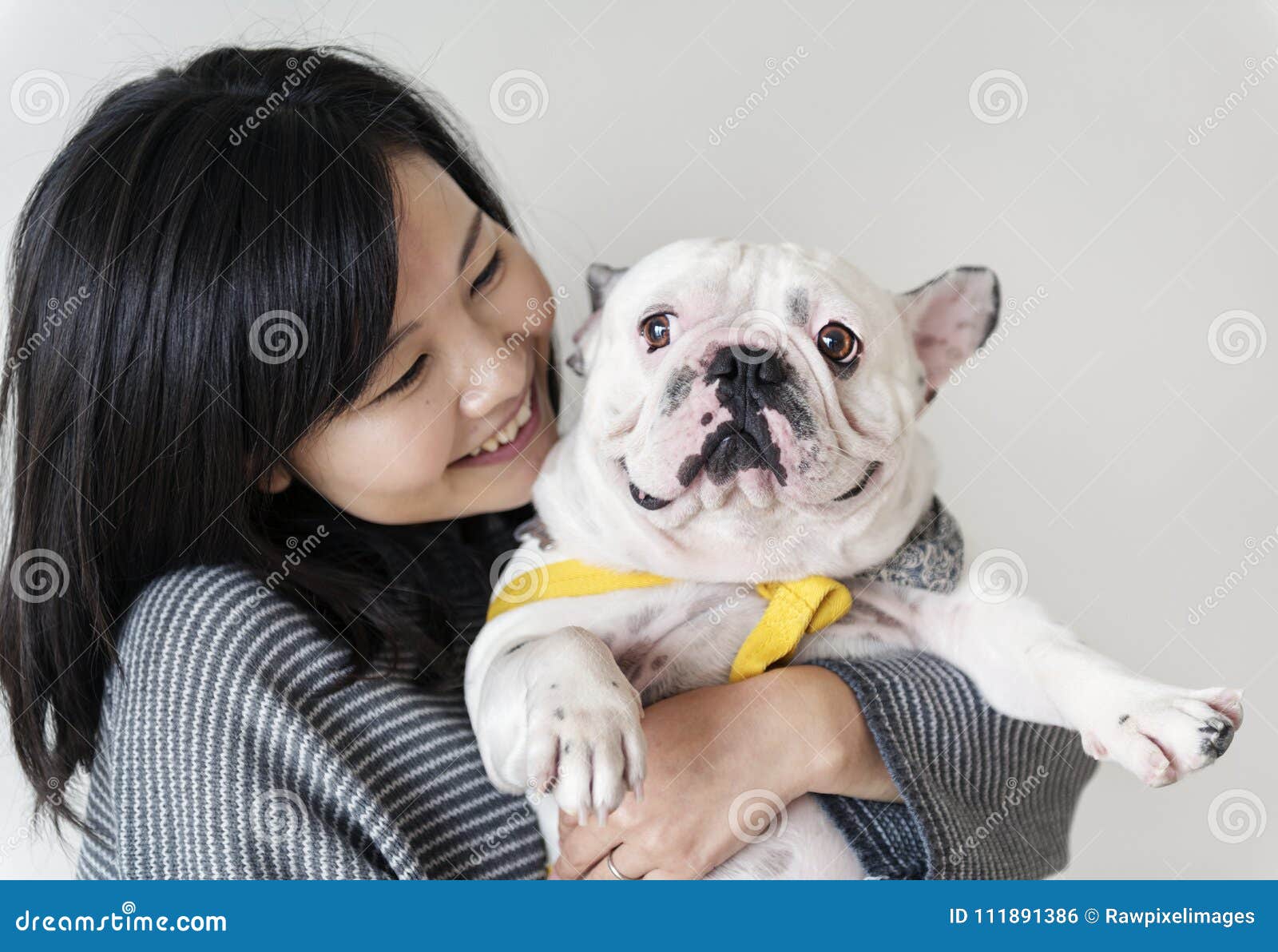 asian woman hugging dog closeup