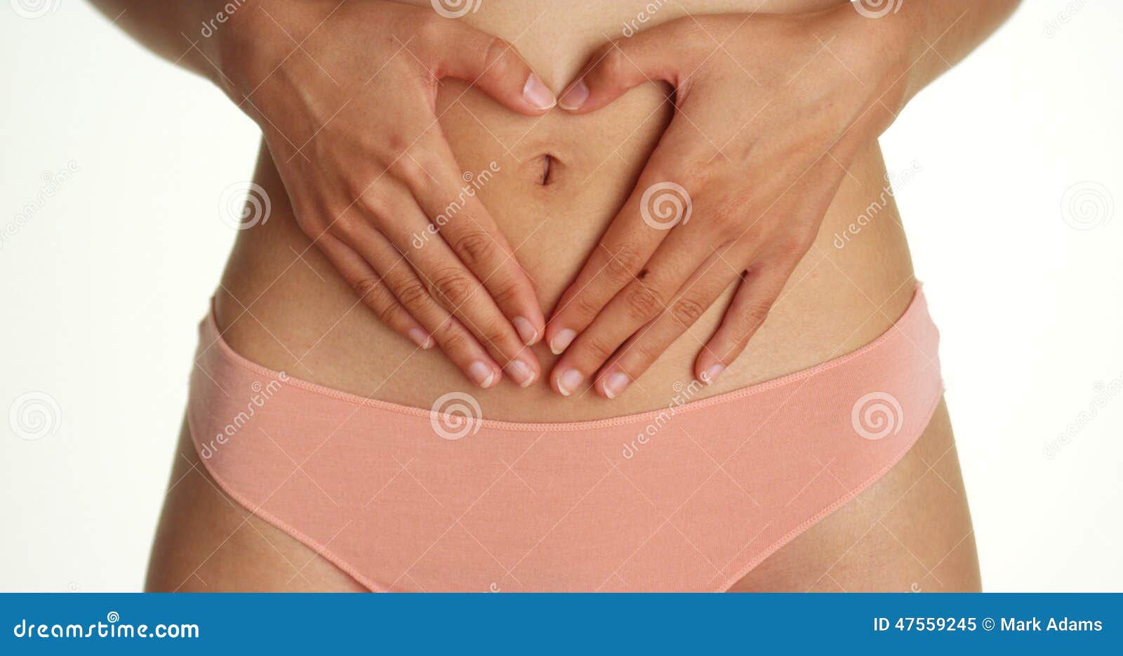 Closeup of fit woman showing her stomach and body in underwear or
