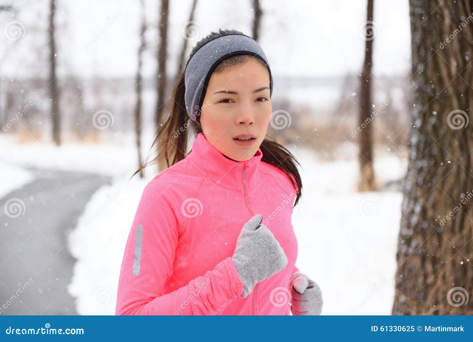 Asian Woman Running in Winter Gloves and Headband Stock Image