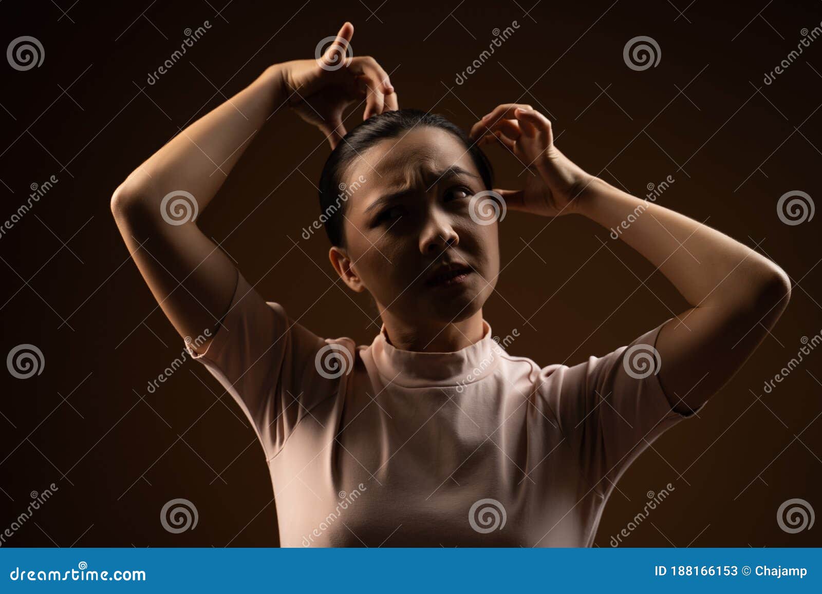 Asian Woman Scratching Her Head Standing Isolated On Beige Background