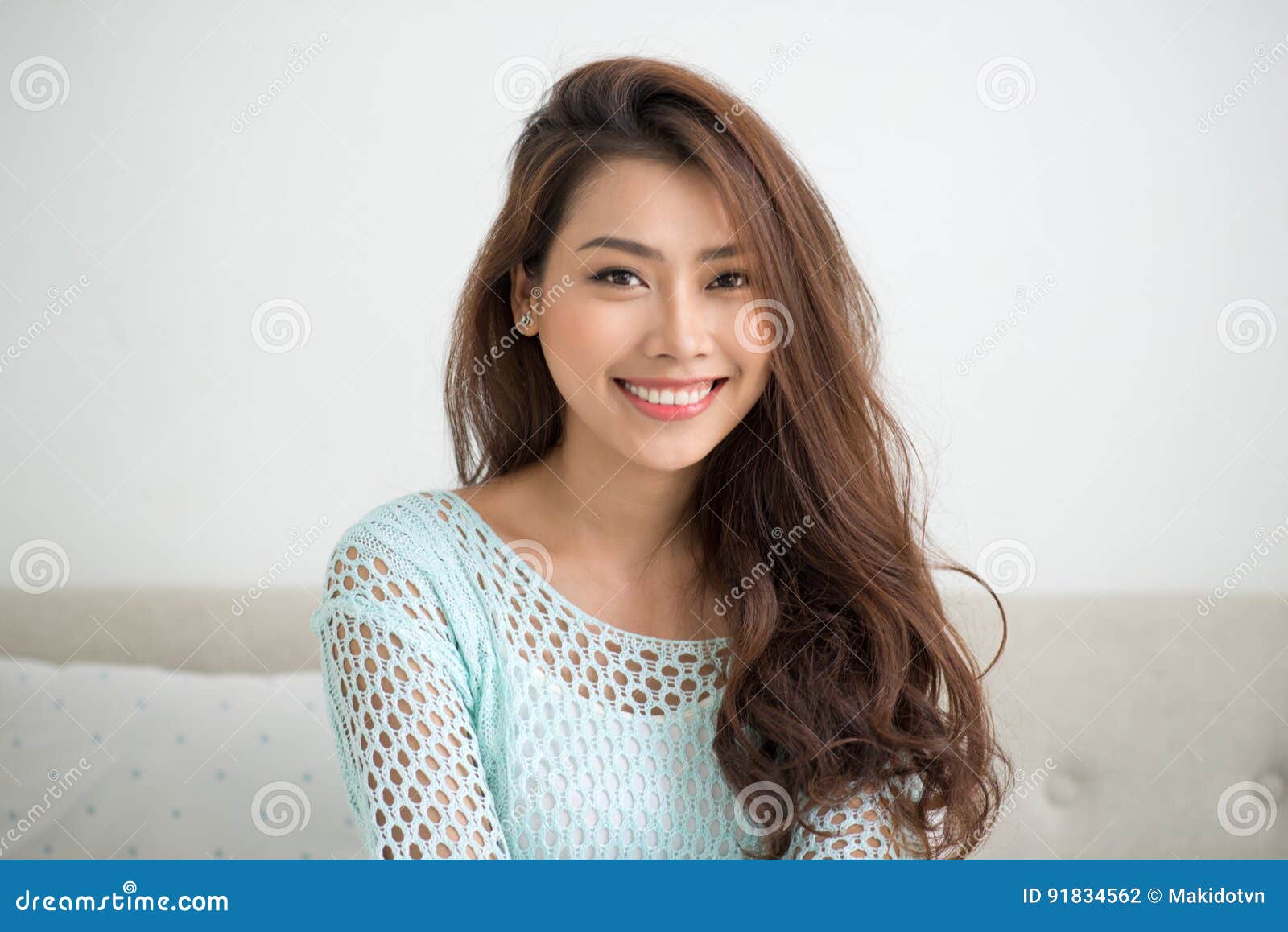 Asian Woman Using Smartphone Sitting on Couch Stock Photo - Image of ...