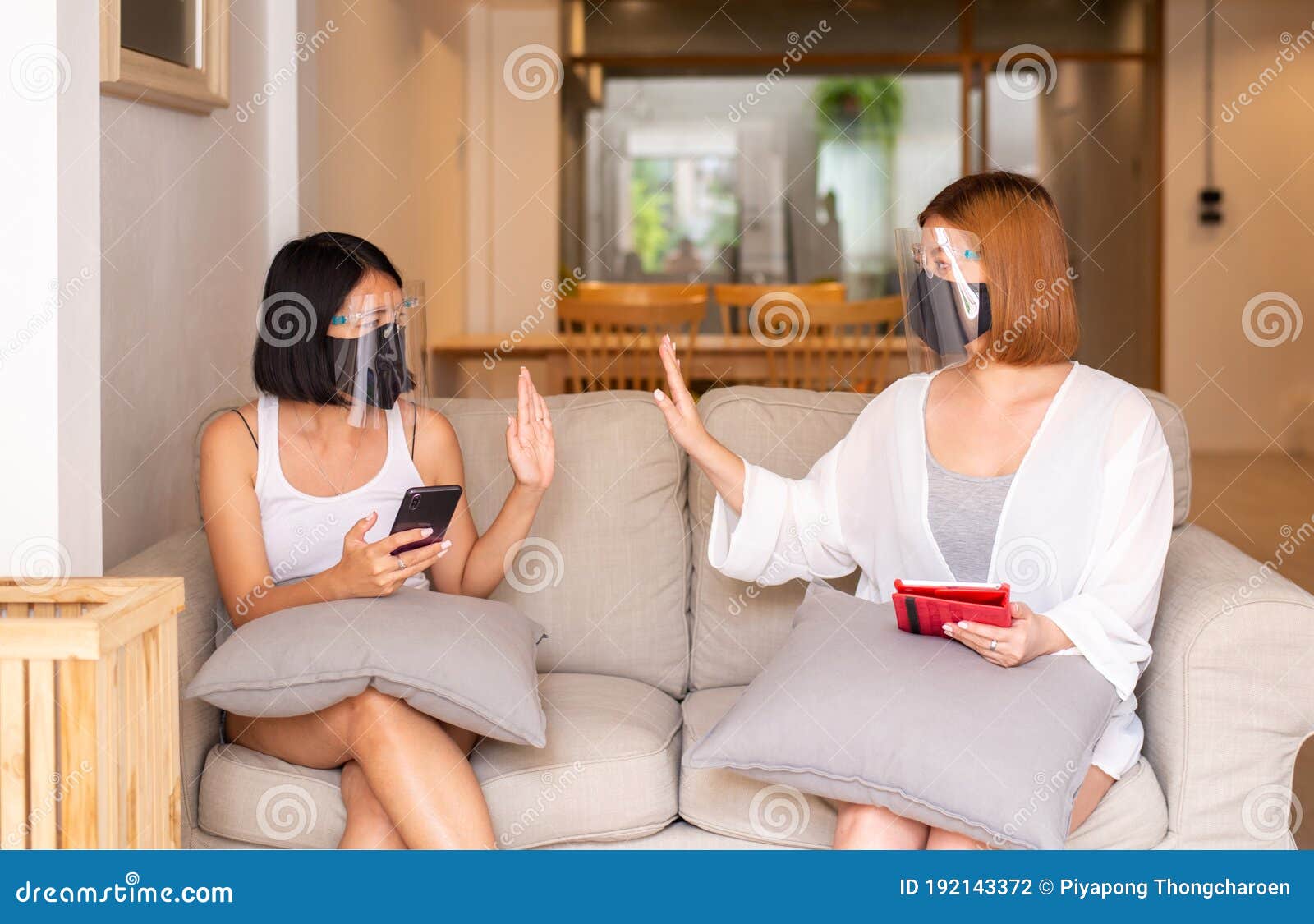 asian woman wearing face shield and protective masks showing no hand touch to avoid contact during corona virus spreading at home,