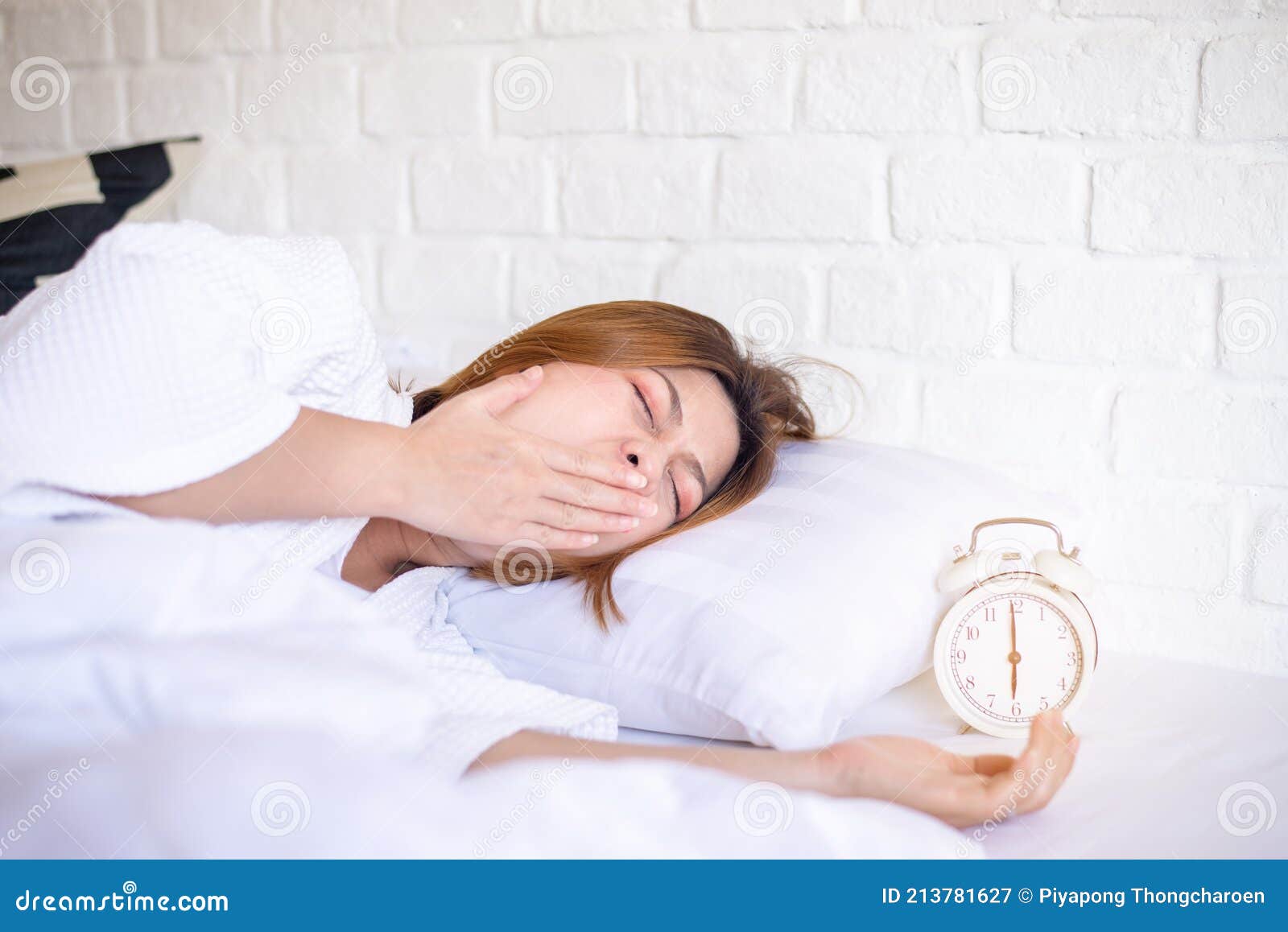 asian woman yawning on bed and tired sleepy,female having symptoms sleepiness