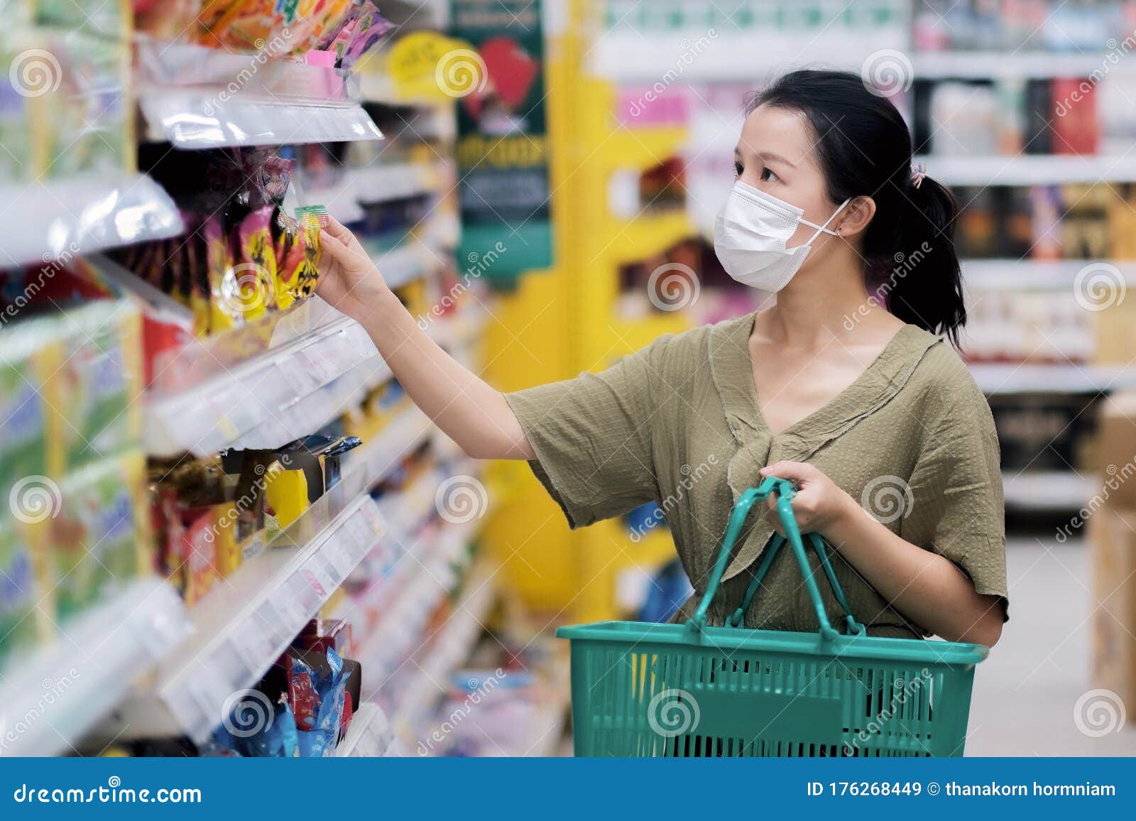 asian women and surgical mask shopping some food in supermarket, covid-19 crisis