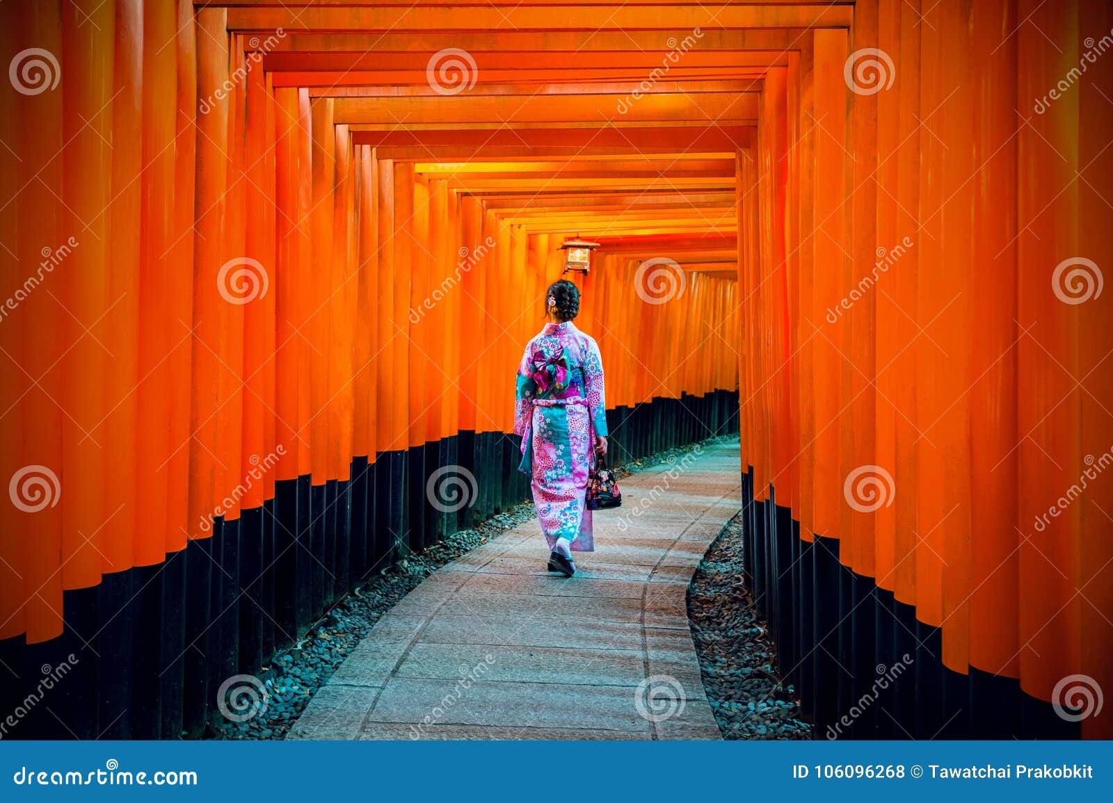 asian women in traditional japanese kimonos at fushimi inari shrine in kyoto, japan