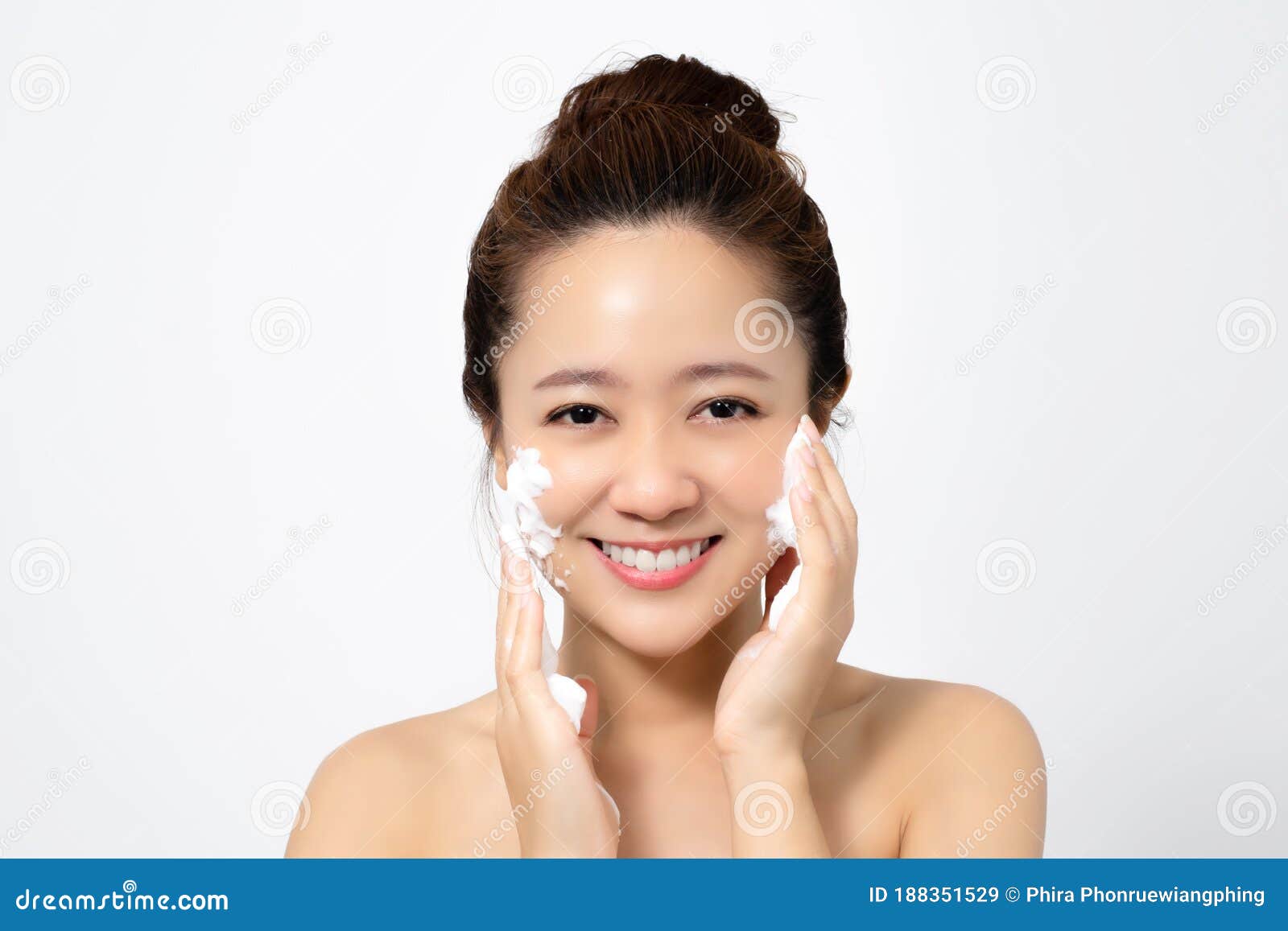 Asian Women are Using Foam To Wash Face in the Studio Stock Image