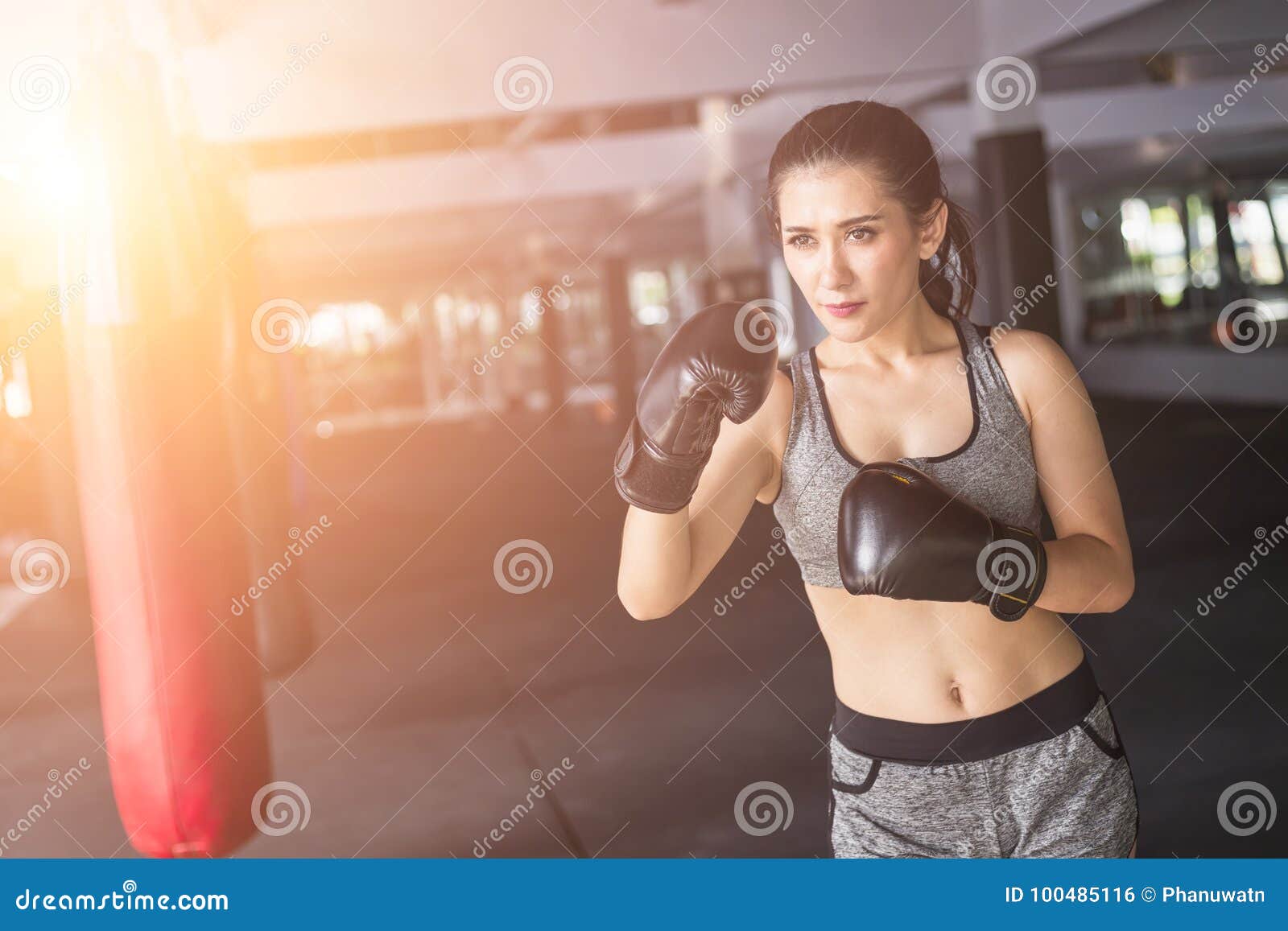 asian young woman doing exercise with thai boxing muay thai eq