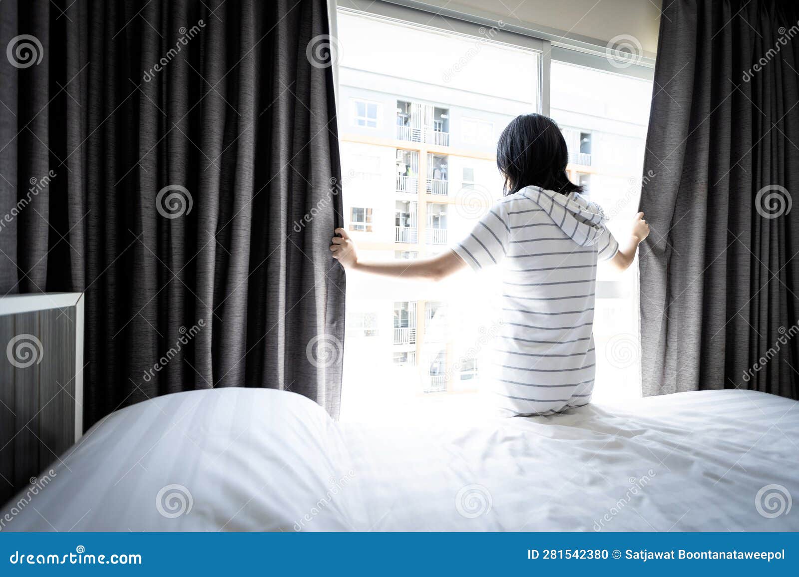 asian young woman opening curtain and window for hygienic,sunlight to enter her bedroom and air circulate freely in room at home,