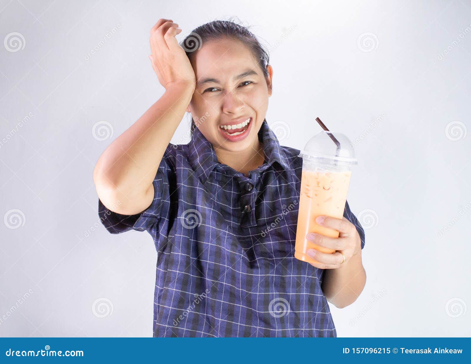 asian young woman touching head with hand because she brain freeze from drinking cold water. health care concept