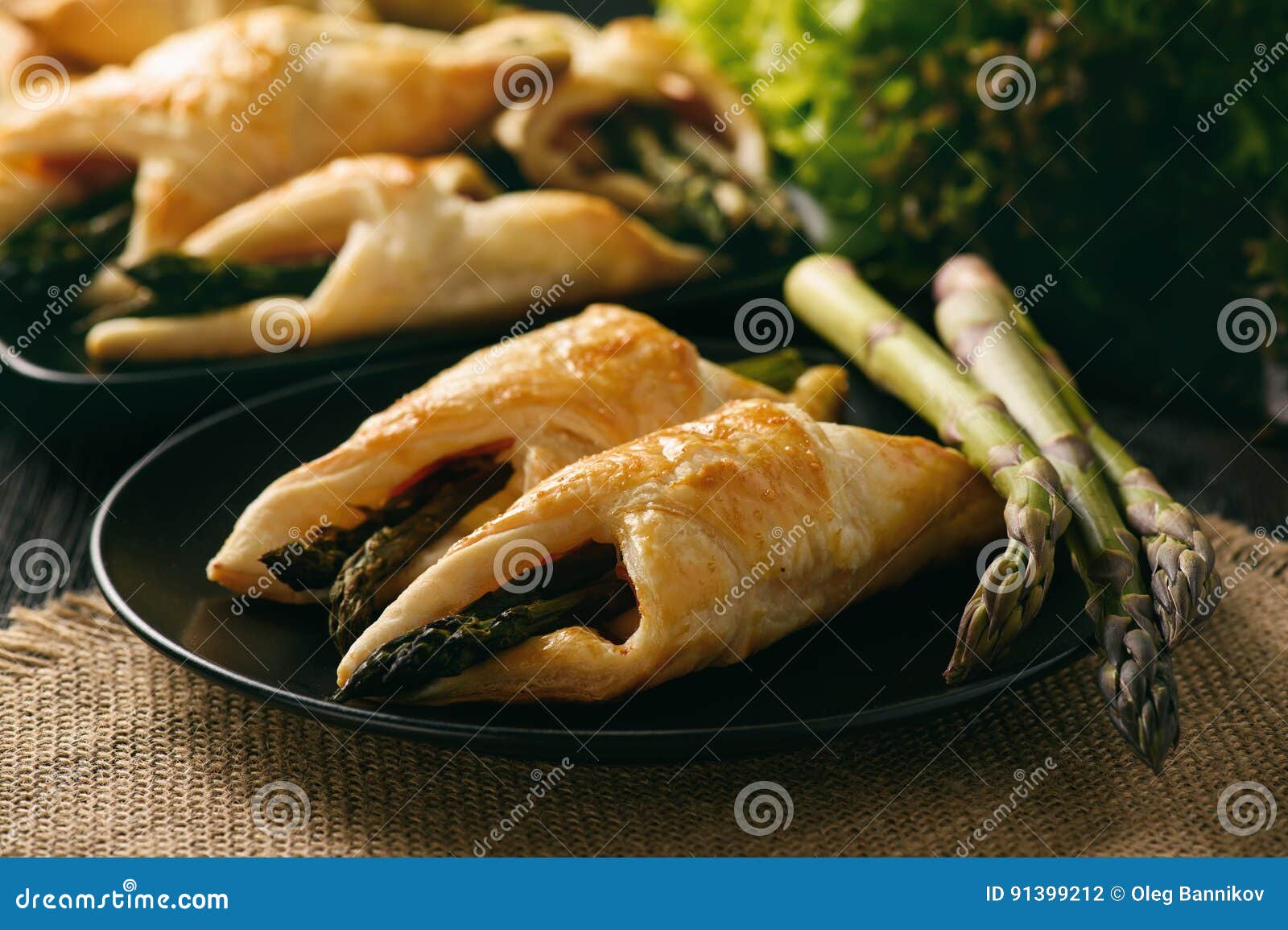 Asparagus Baked in Puff Pastry with Ham and Cheese. Stock Photo Image