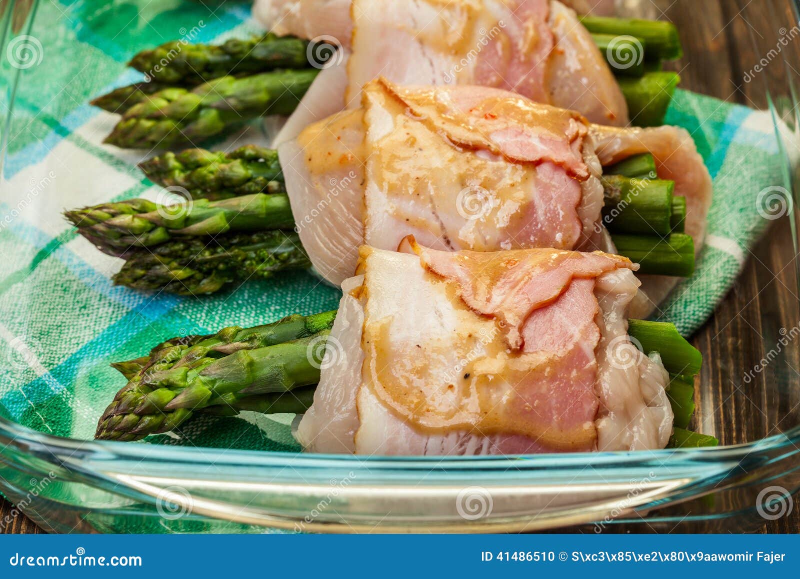 Asparagus Wrapped in Chicken and Bacon in a Baking Dish Stock Photo