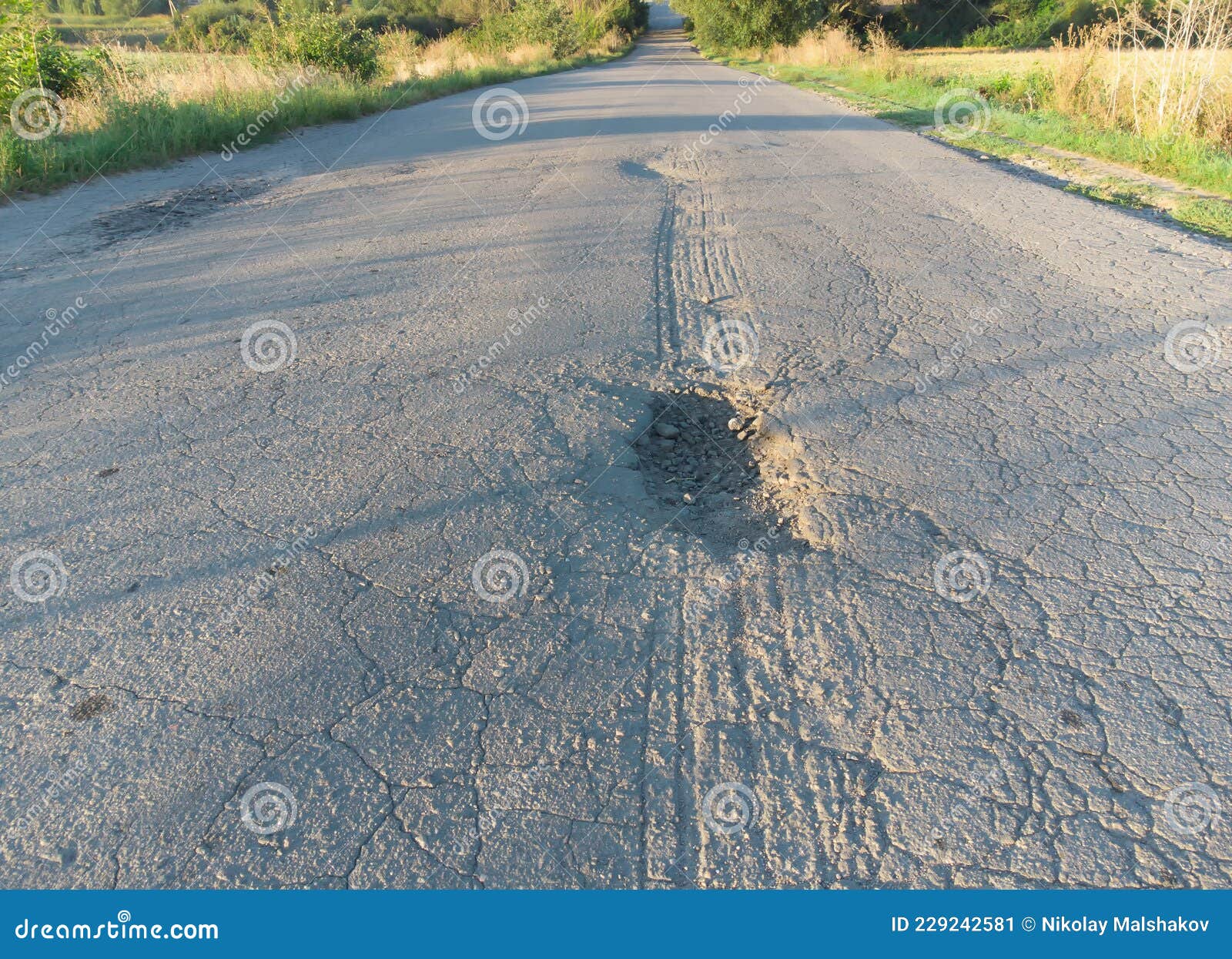 Asphalt Road in Poor Condition with Potholes and Potholes Stock Image