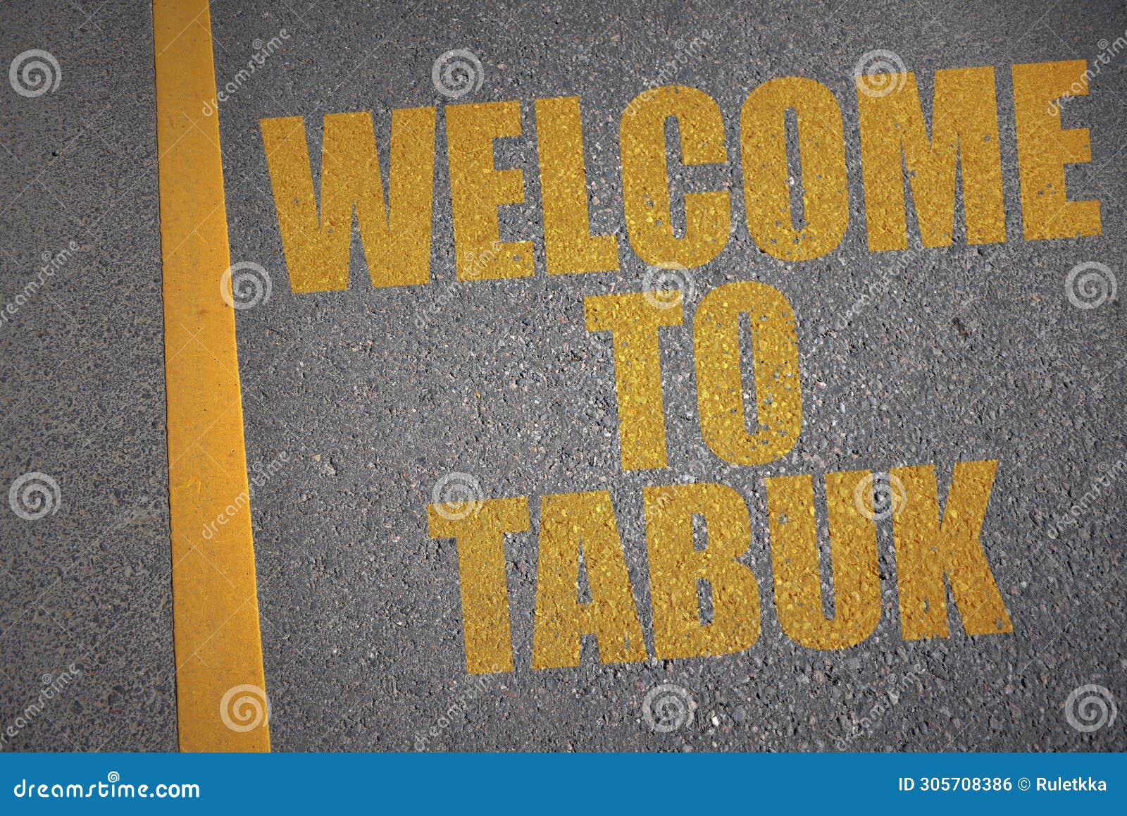 asphalt road with text welcome to tabuk near yellow line