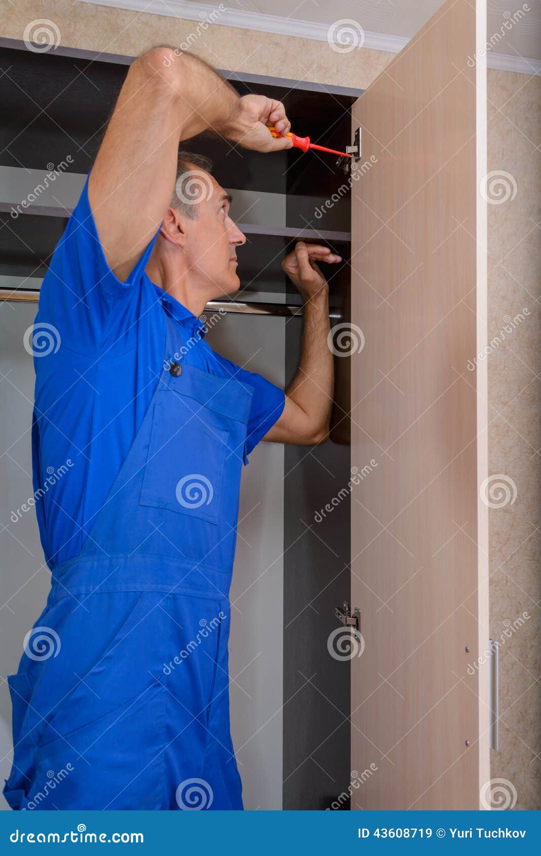 Assembler of furniture stock image. Image of wardrobe 43608719