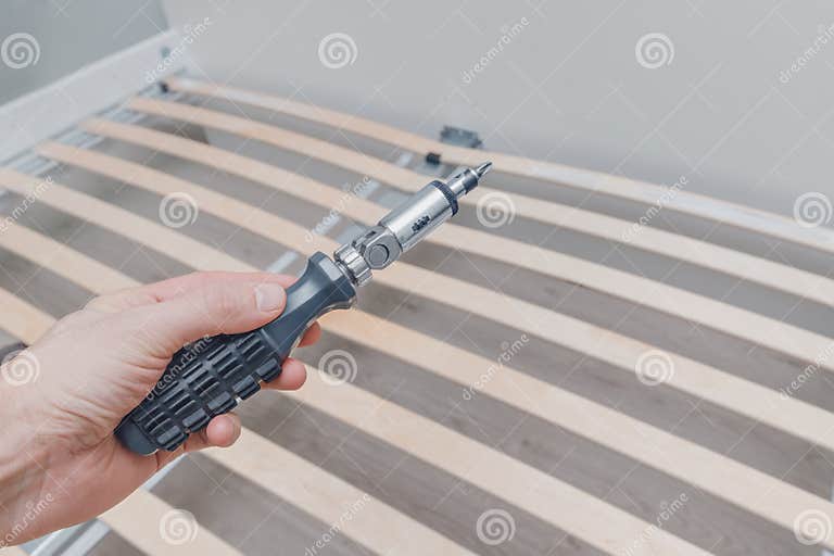 Assembling a Frame for Mattress with Wooden Planks Called a Rackand