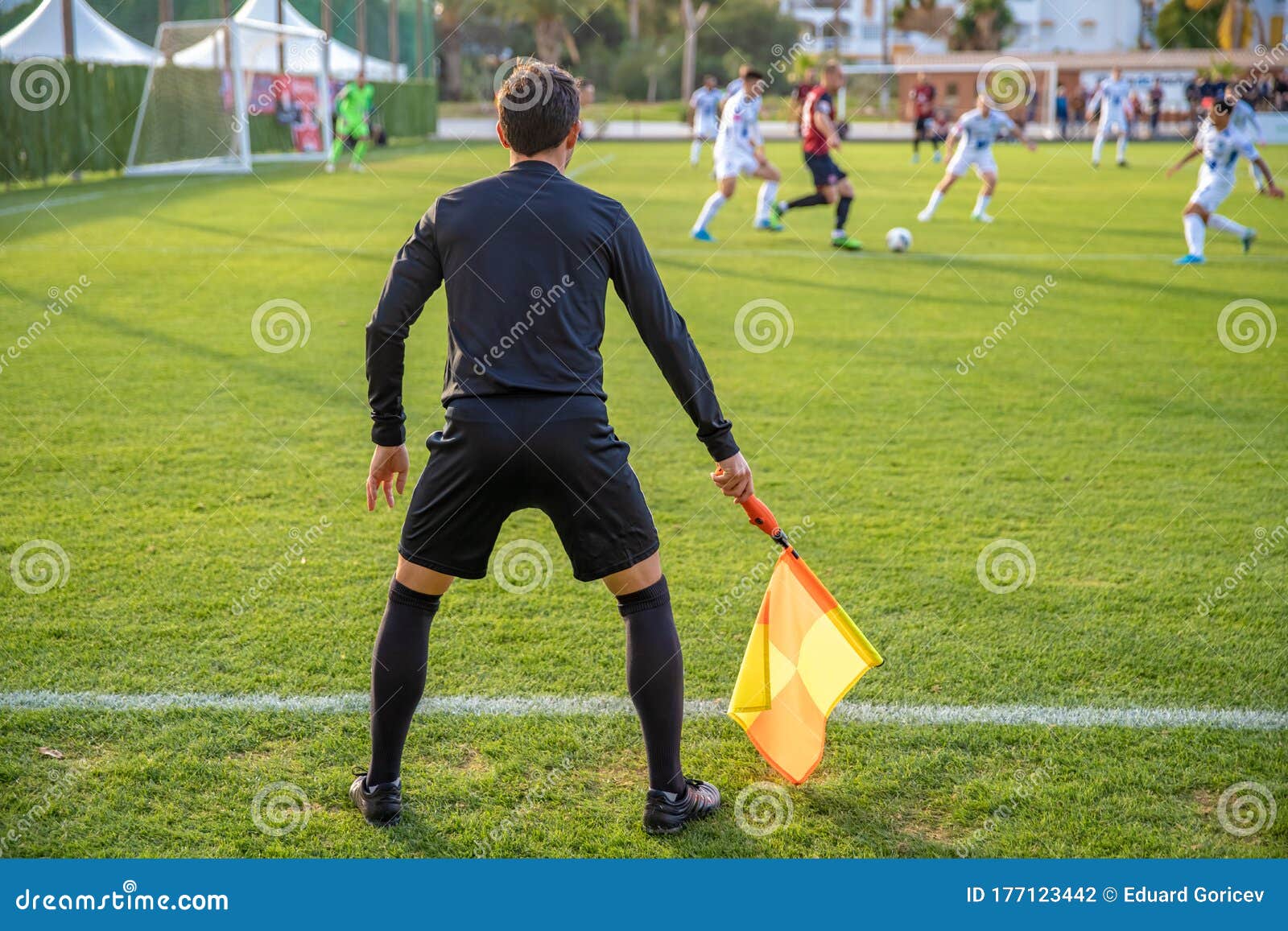 Assistant Referee in a Football Match Watching the Game Editorial