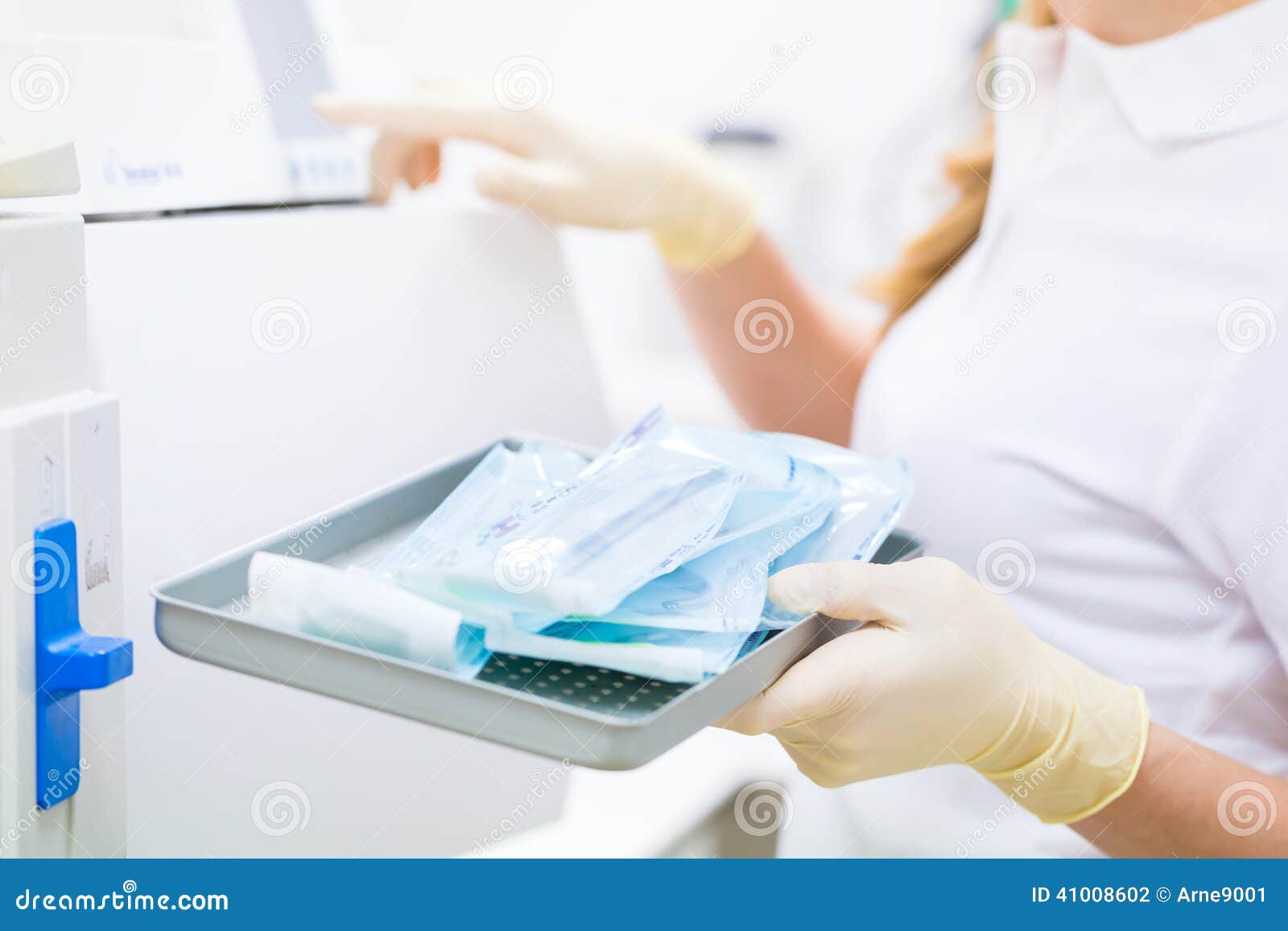 assistant with sterile dentist tools