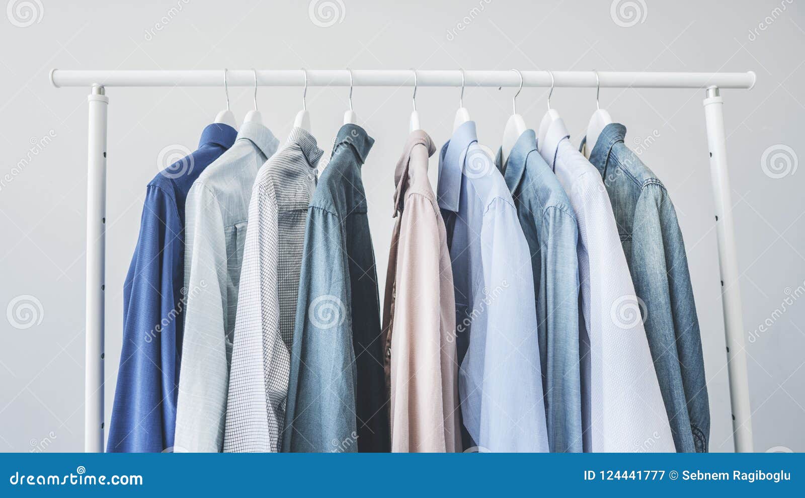 Assorted Blue Shirts Hanging on Wooden Hangers Stock Image Image of