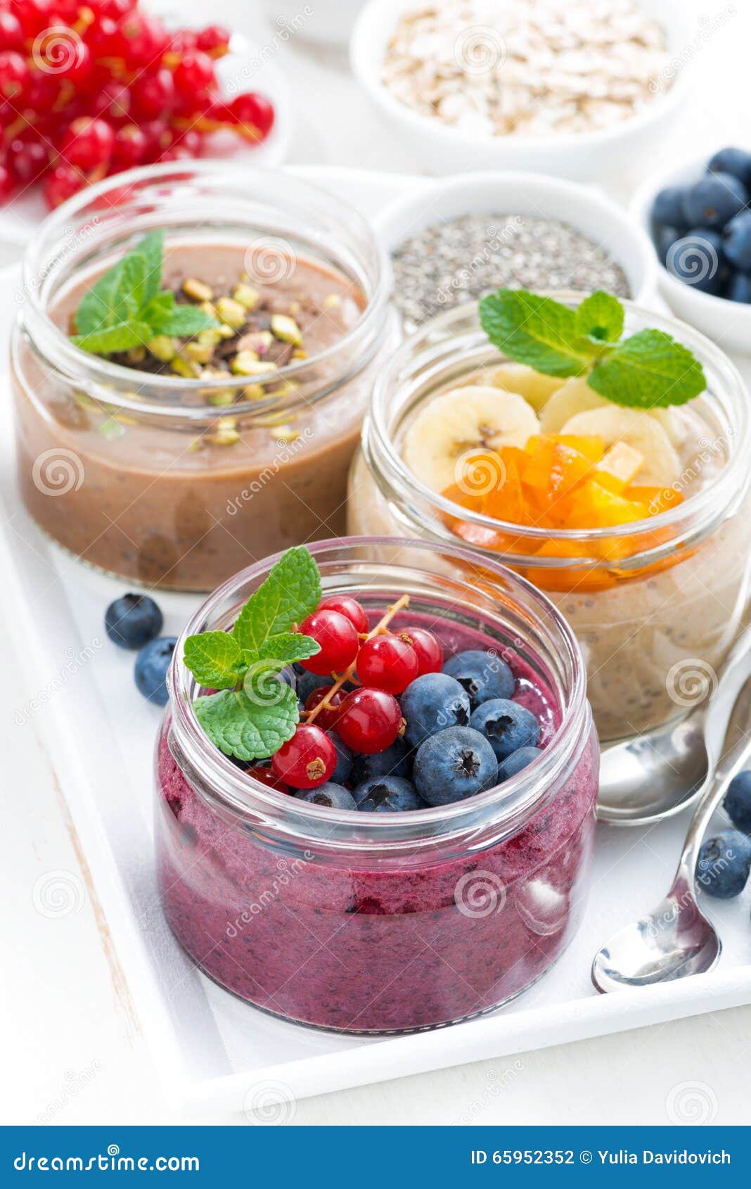 Assorted Breakfast of Chia Seeds and Fruits in Jars, Vertical Stock