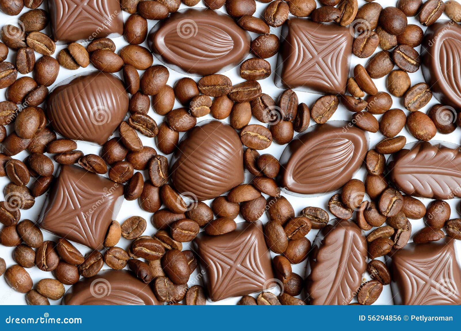 Assorted Chocolate Candy on the Background of Coffee Beans Isolated