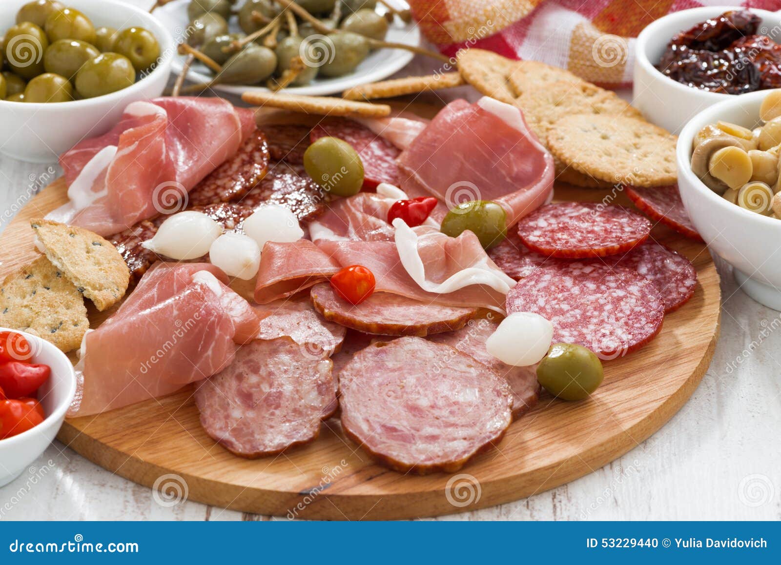 Assorted Deli Meat Snacks, Sausages and Pickles on Board Stock Photo